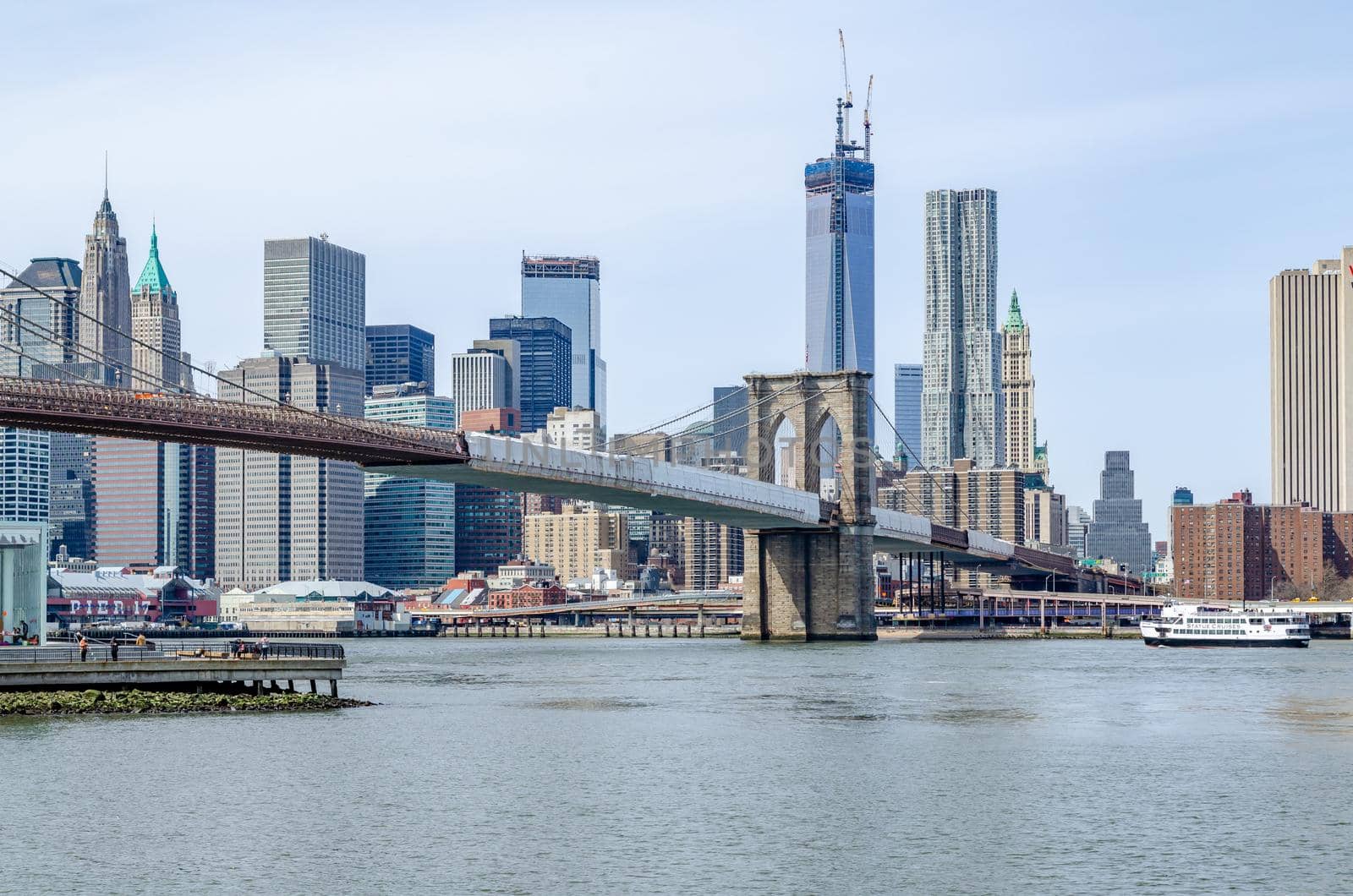 Brooklyn Bridge New York City and Hudson river with Manhattan Skyline in the Background by bildgigant