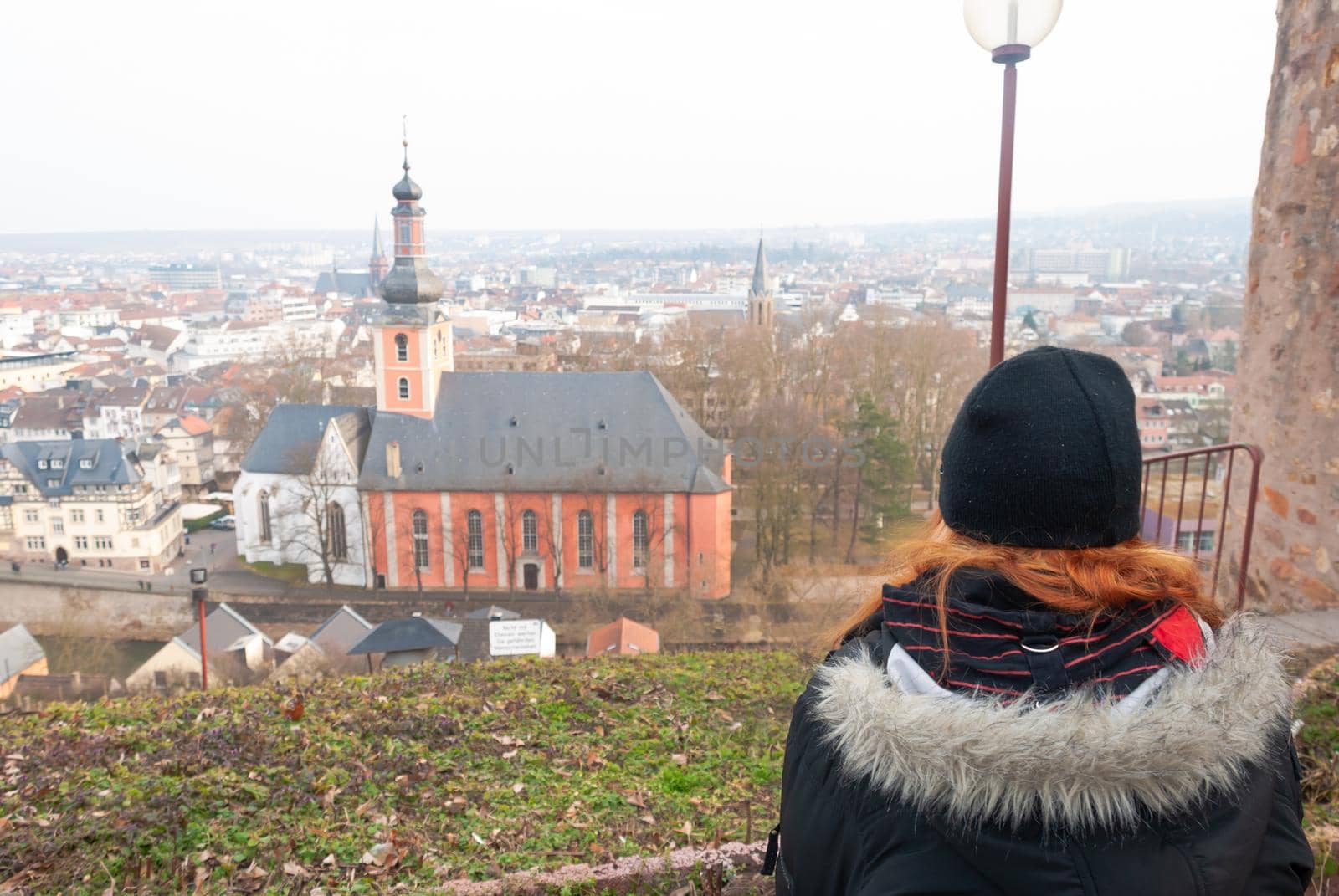 Young alternative punk emo girl looking at view, Bad Kreuznach, Germany while sitting on a observation point, horizontal