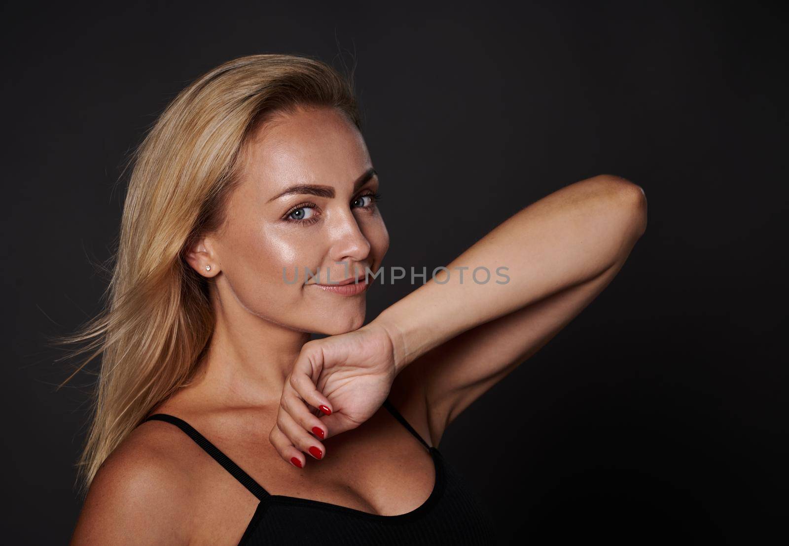 Headshot attractive beautiful woman with shining glowing fresh tanned skin, in underwear cutely smiling looking at camera isolated over black background, copy space. Self acceptance, Body positivity