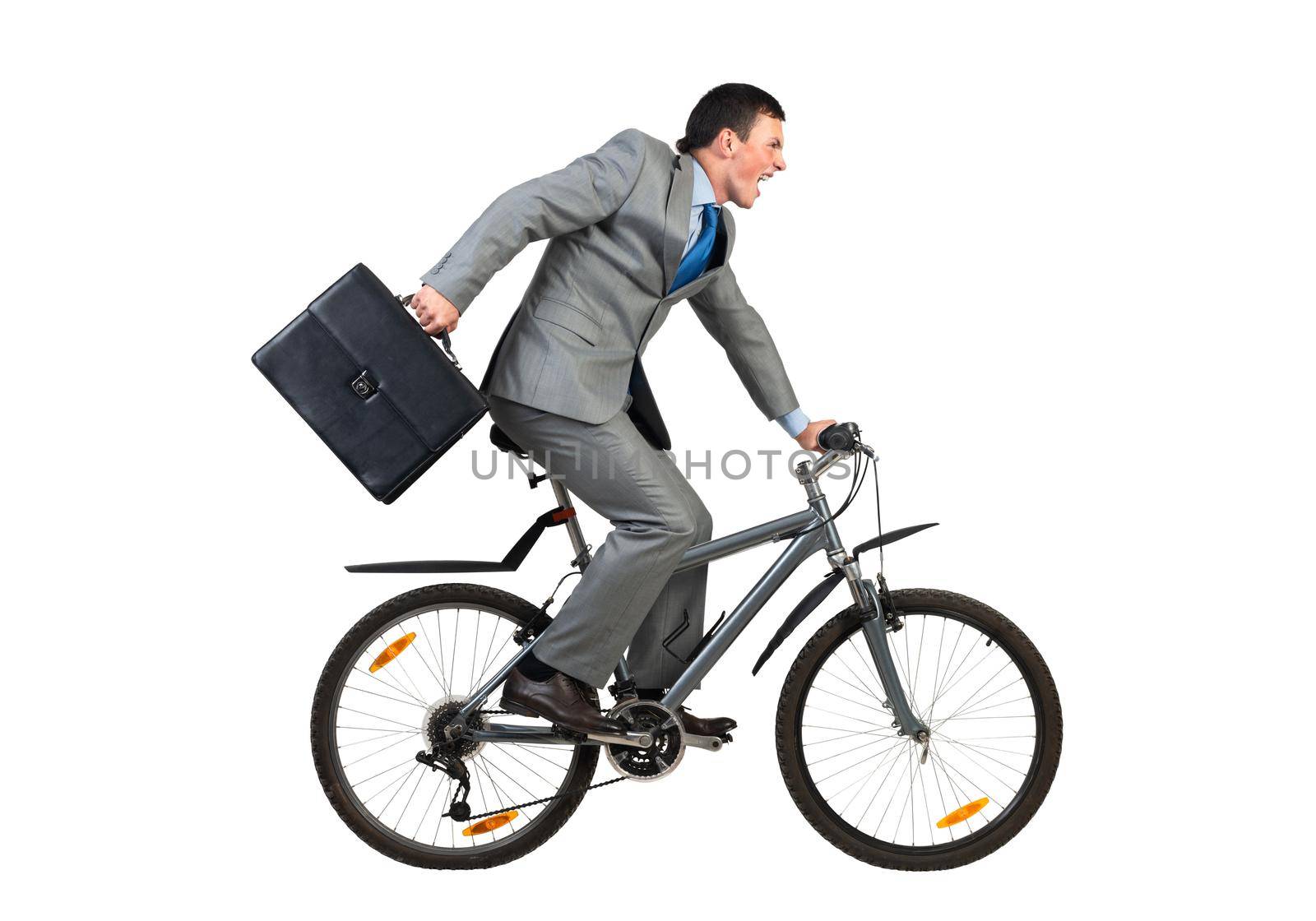 Businessman on bike hurry to work. Young man scared to be late. Corporate employee in grey business suit with suitcase riding bicycle. Male cyclist isolated on white background. Rush hour concept
