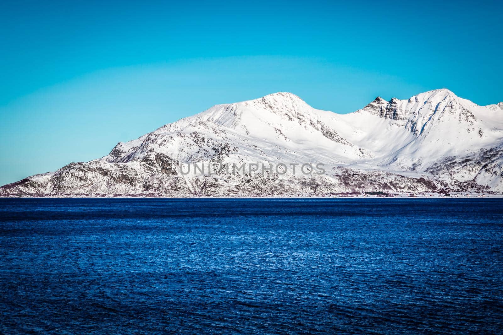 Snow Mountain with Fjord in foreground (Norway near Tromso) by bildgigant