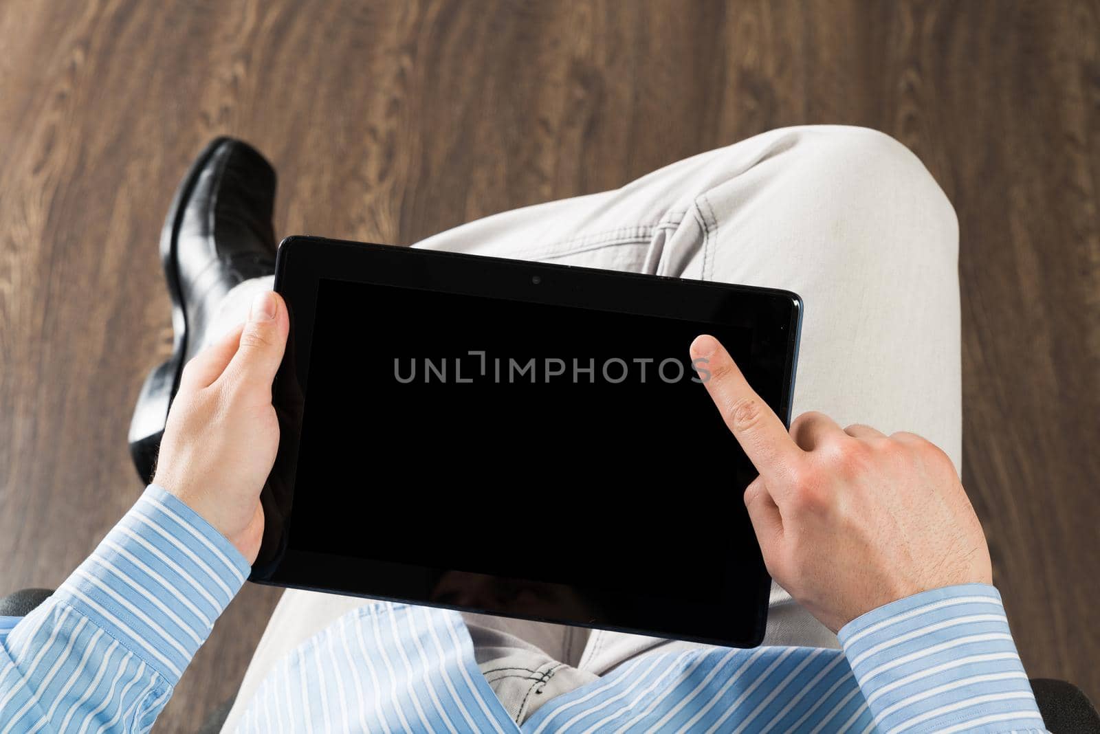 close-up of men's hands with a computer tablet. Businessman works in the office