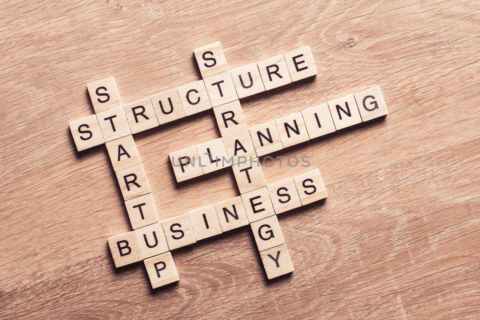 Conceptual business keywords on table with elements of game making crossword by adam121