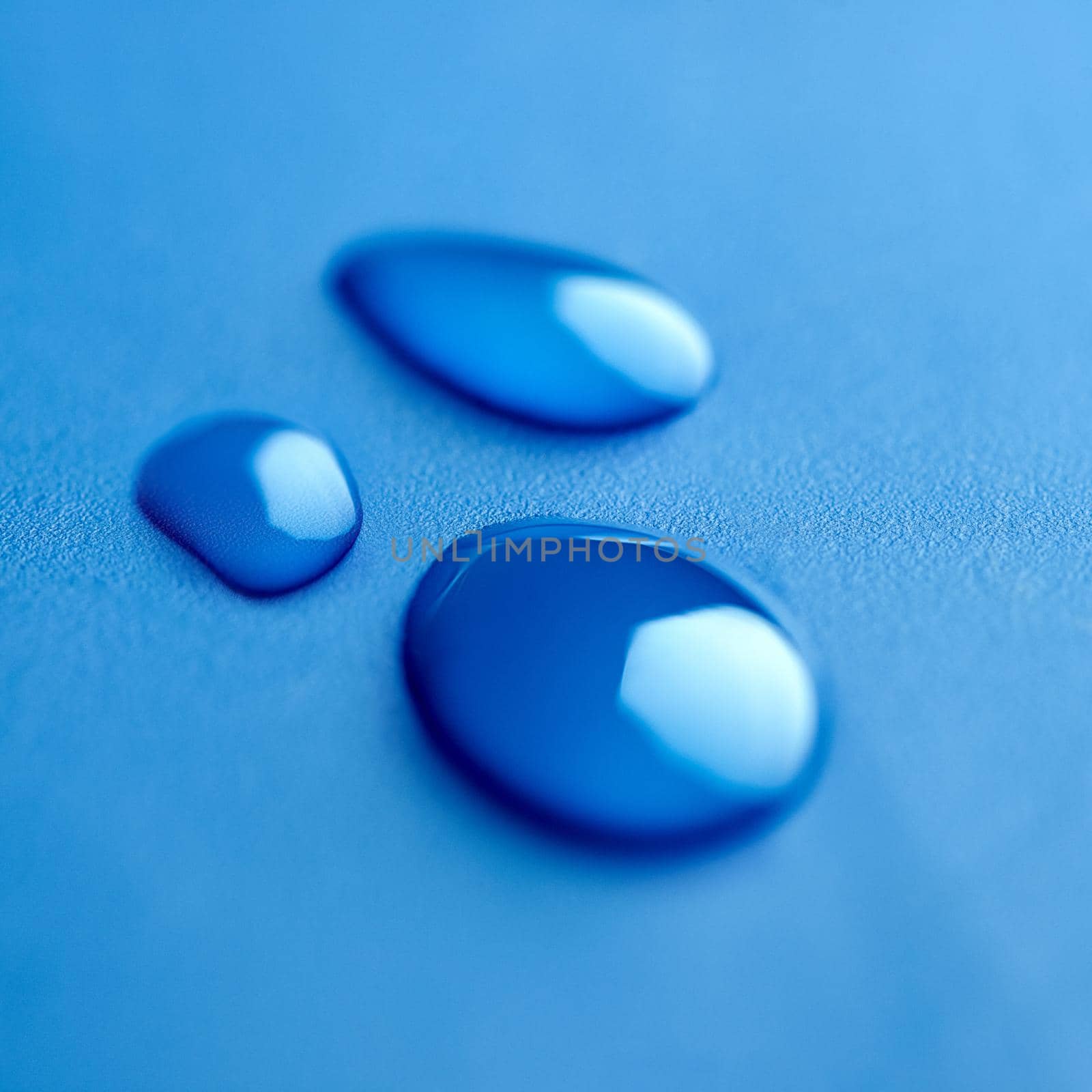 Trio in blue. Shot of drops of water. by YuriArcurs