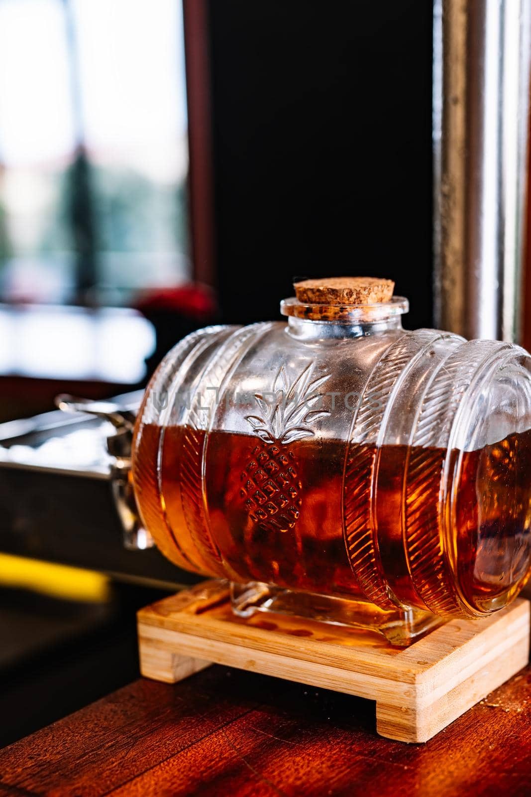 detail of a barrel of sweet wine on the counter of a bar by CatPhotography