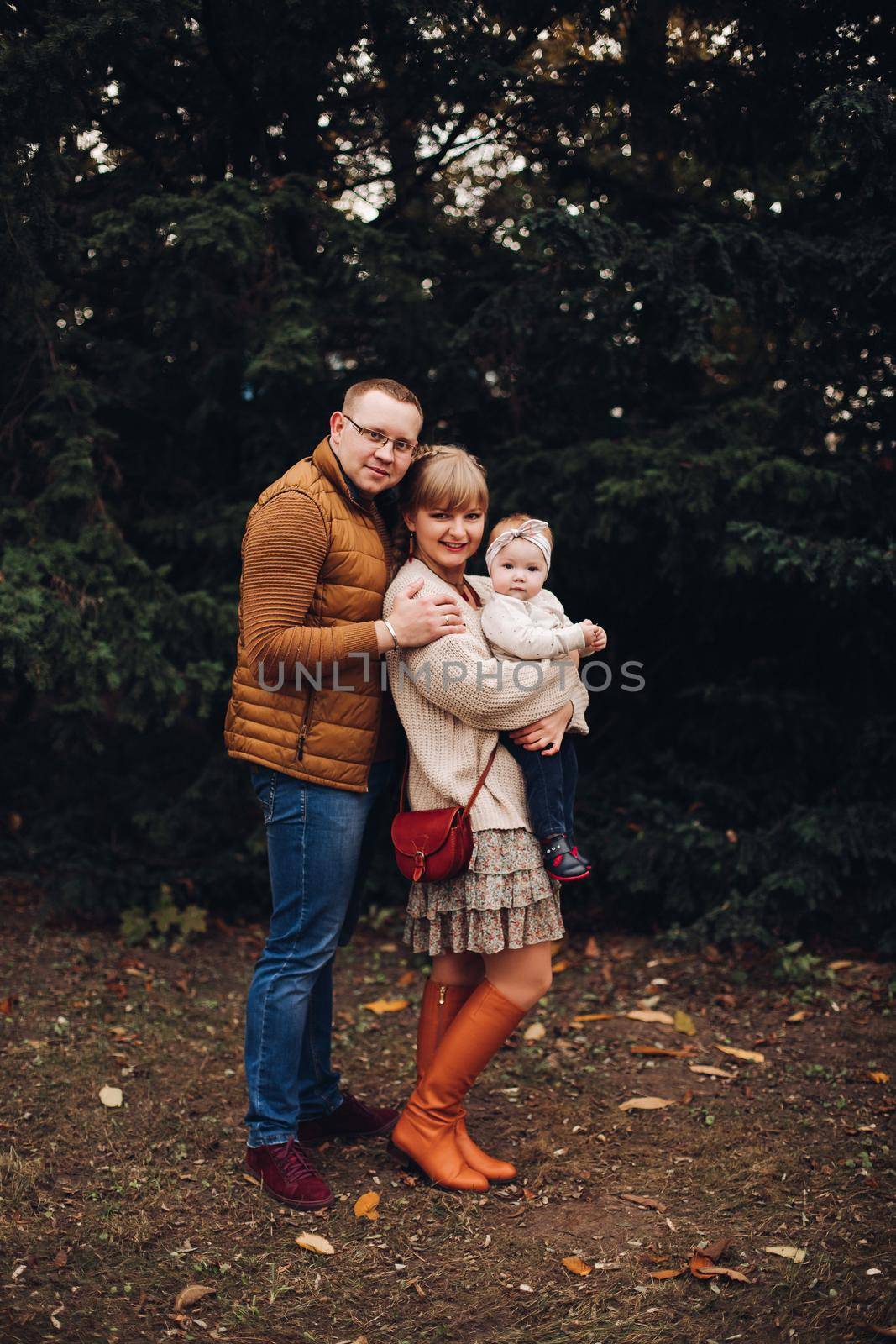 Beautiful and happy family with little child in park. by StudioLucky