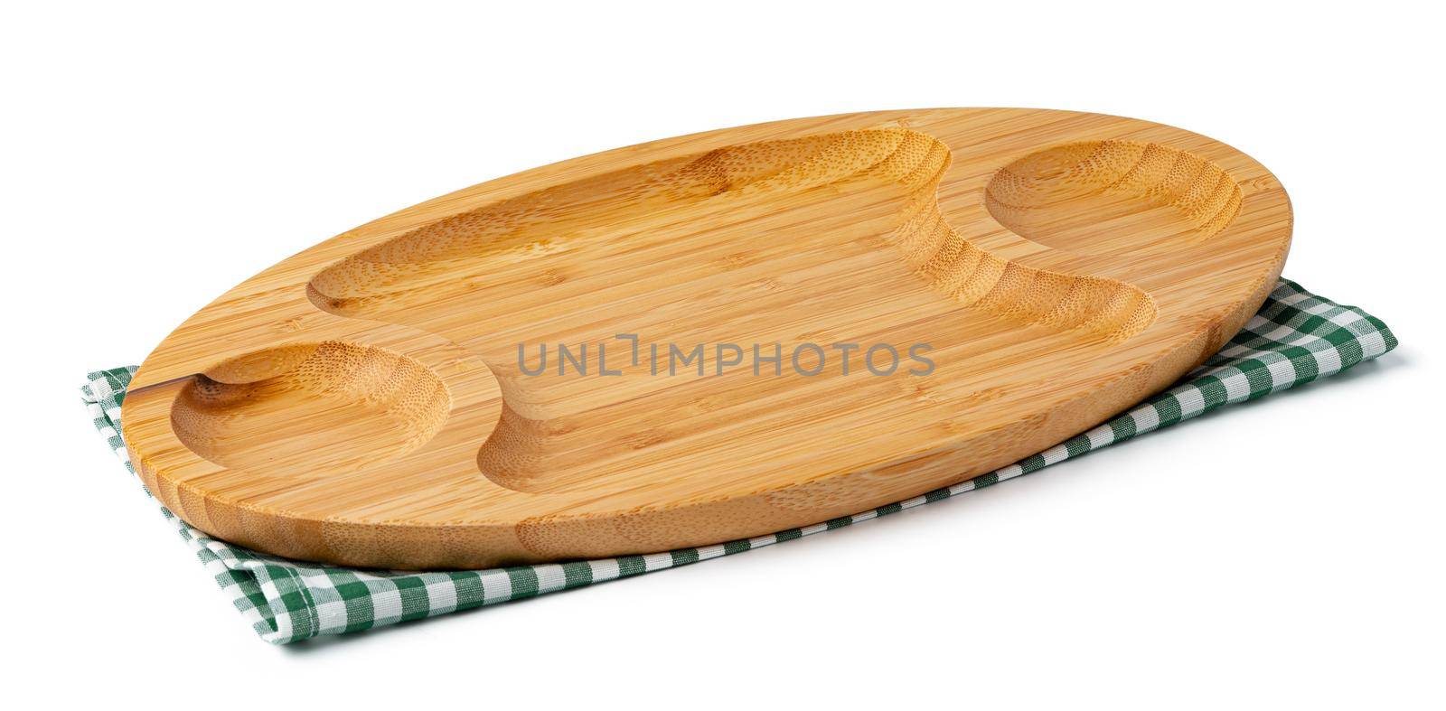 Wooden plate and tablecloth on white background, close up
