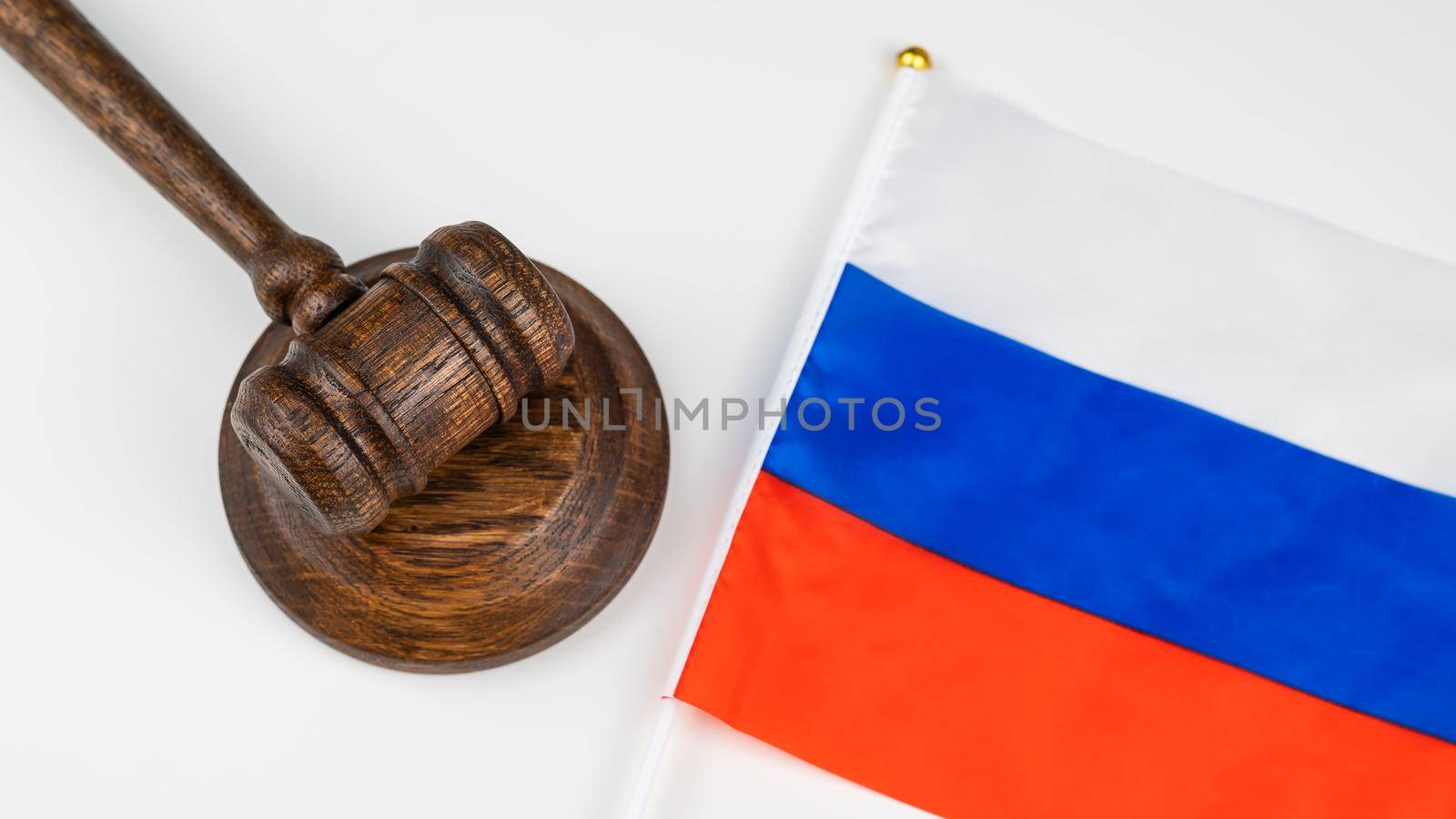 Russian federation flag and judge's gavel on a white table
