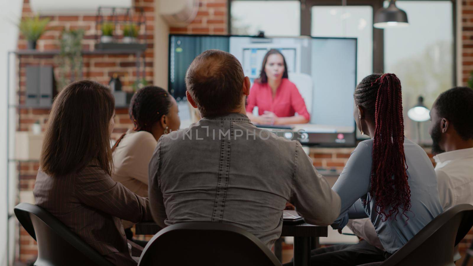 Business people talking on video call communication with woman by DCStudio