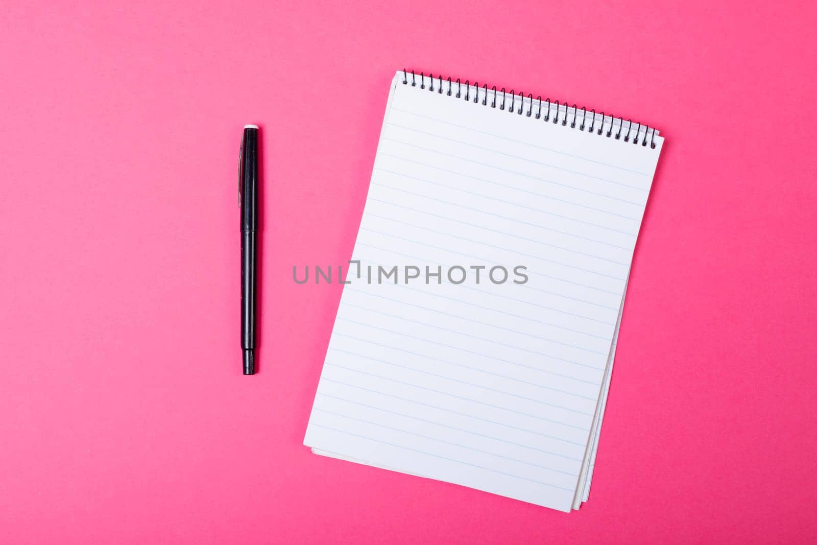 Composition of notebook with copy space and pen on pink background. communication, tradition and celebration concept.