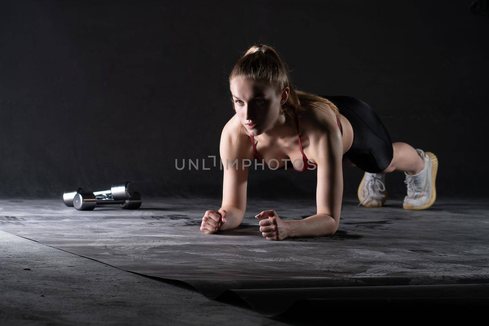 The girl on in the dumbbells plank stands a with floor push-ups looks like a kira knightley girl fitness black, for caucasian female in young from healthy bodybuilding, dumbbell sexy. Wellness