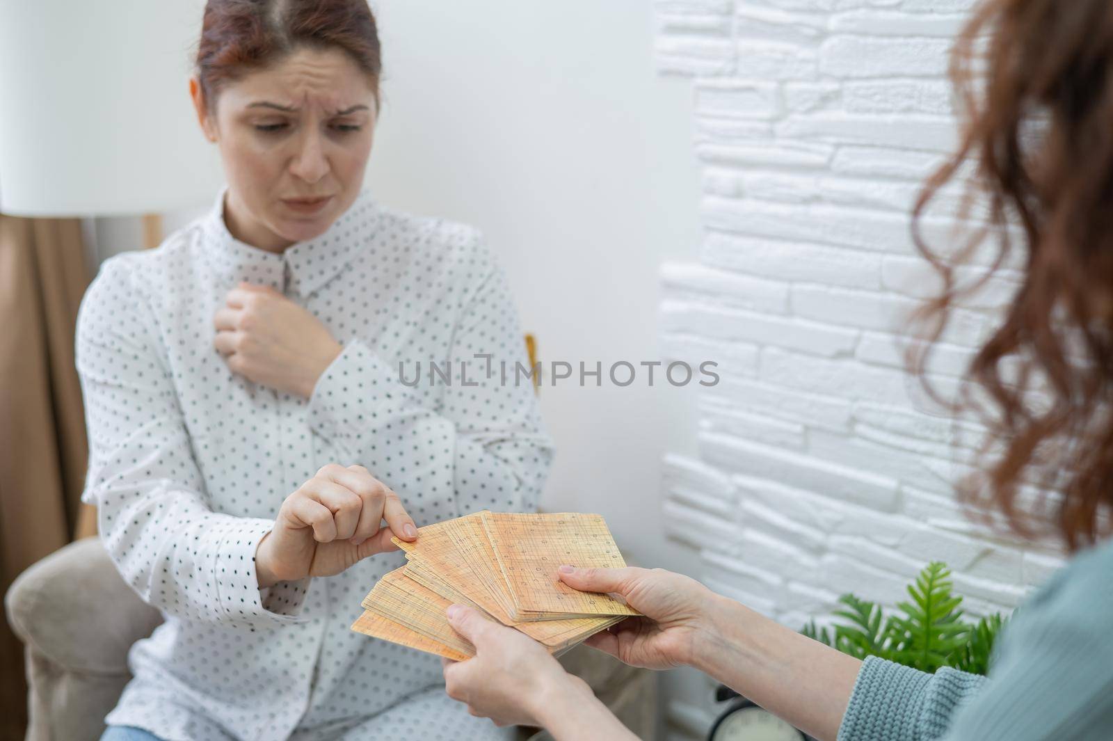 Psychologist uses metaphorical associative cards in a session with a patient