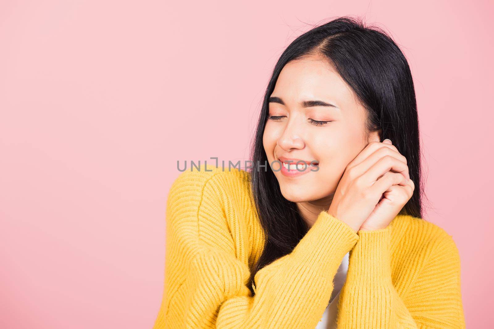 Happy Asian portrait beautiful cute young cheerful mixed race woman smile shy satisfied expression, studio shot isolated pink background, Thai female bashful pleasure put both hand on face, copy space