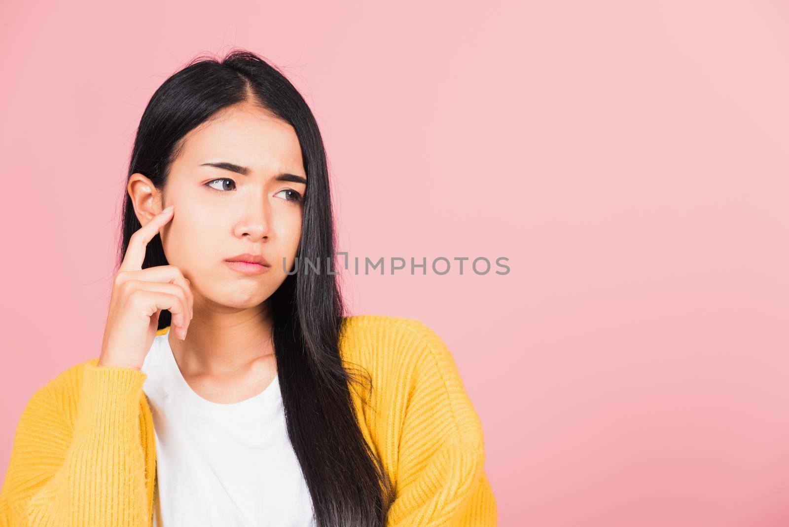 Portrait Asian beautiful young woman standing chin handle relaxed thinking about something about the question studio shot isolated on pink background, Thai female idea think with copy space