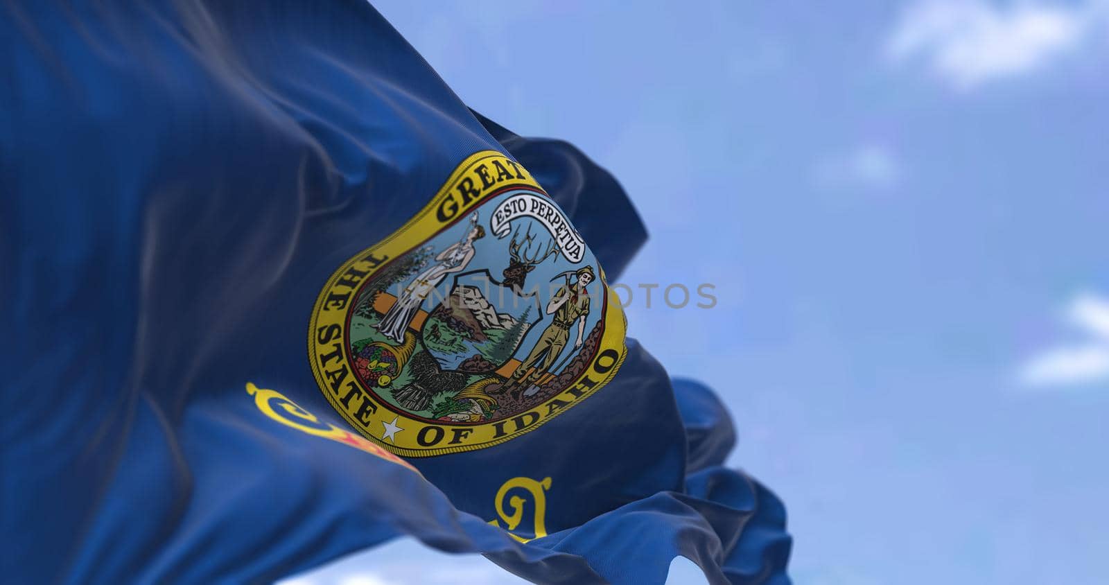 The US state flag of Idaho waving in the wind. Idaho is a state in the Pacific Northwest region of the United States. Democracy and independence.