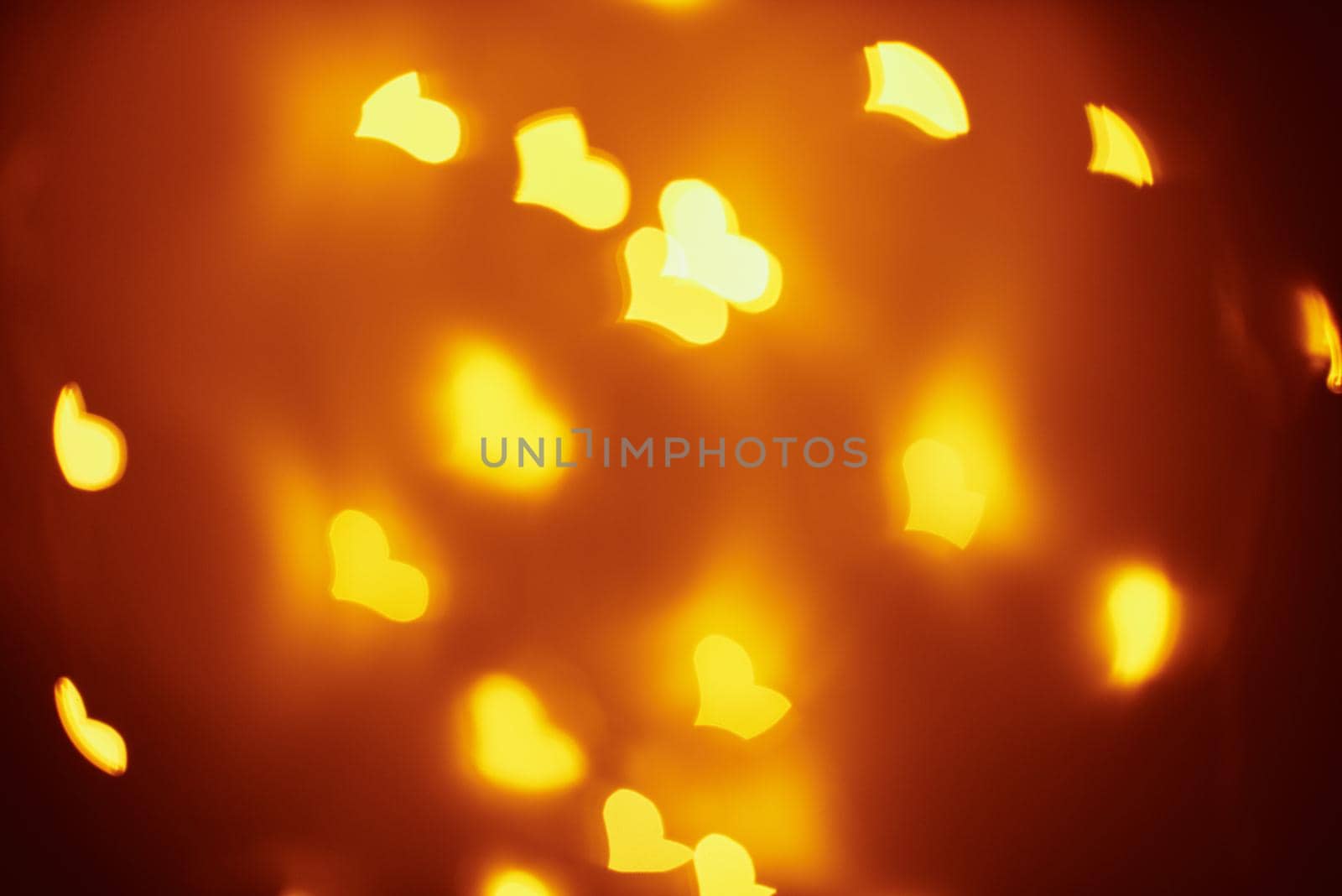 Abstract background with a golden blurred lights in heart shape. Valentine day concept by Lazy_Bear