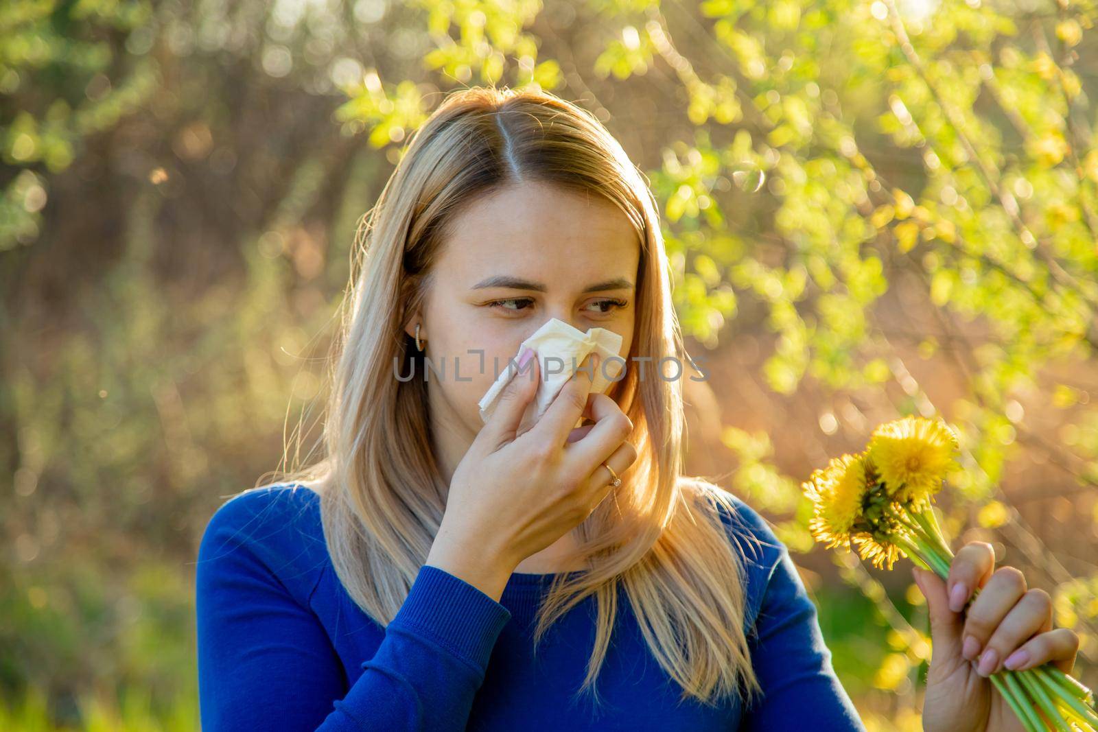 The girl is allergic to flowers in the field.