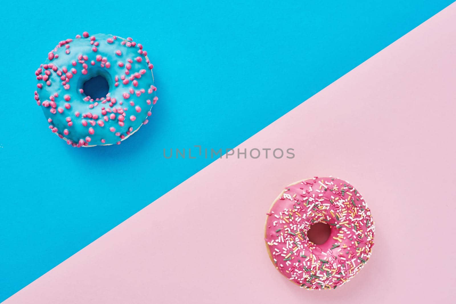 Two donuts on a pastel pink and blue background. Minimalism creative food composition. Flat lay style by Lazy_Bear