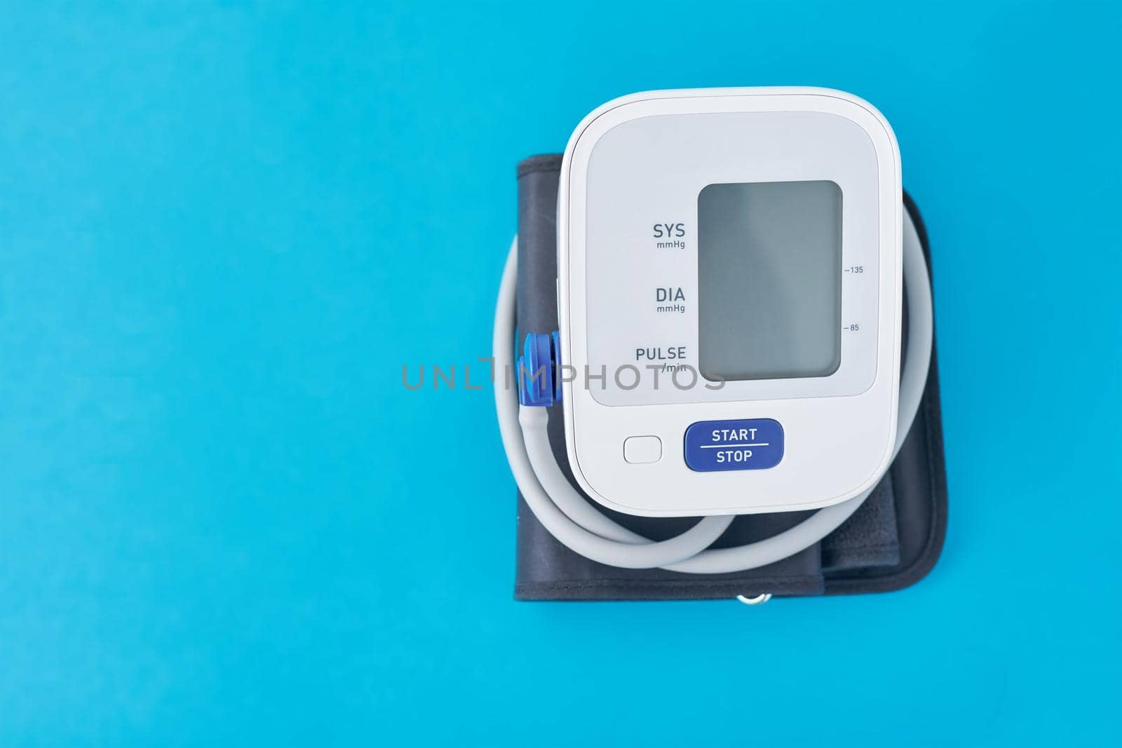 Digital blood pressure monitor on a blue background, closeup. Helathcare and medical concept by Lazy_Bear