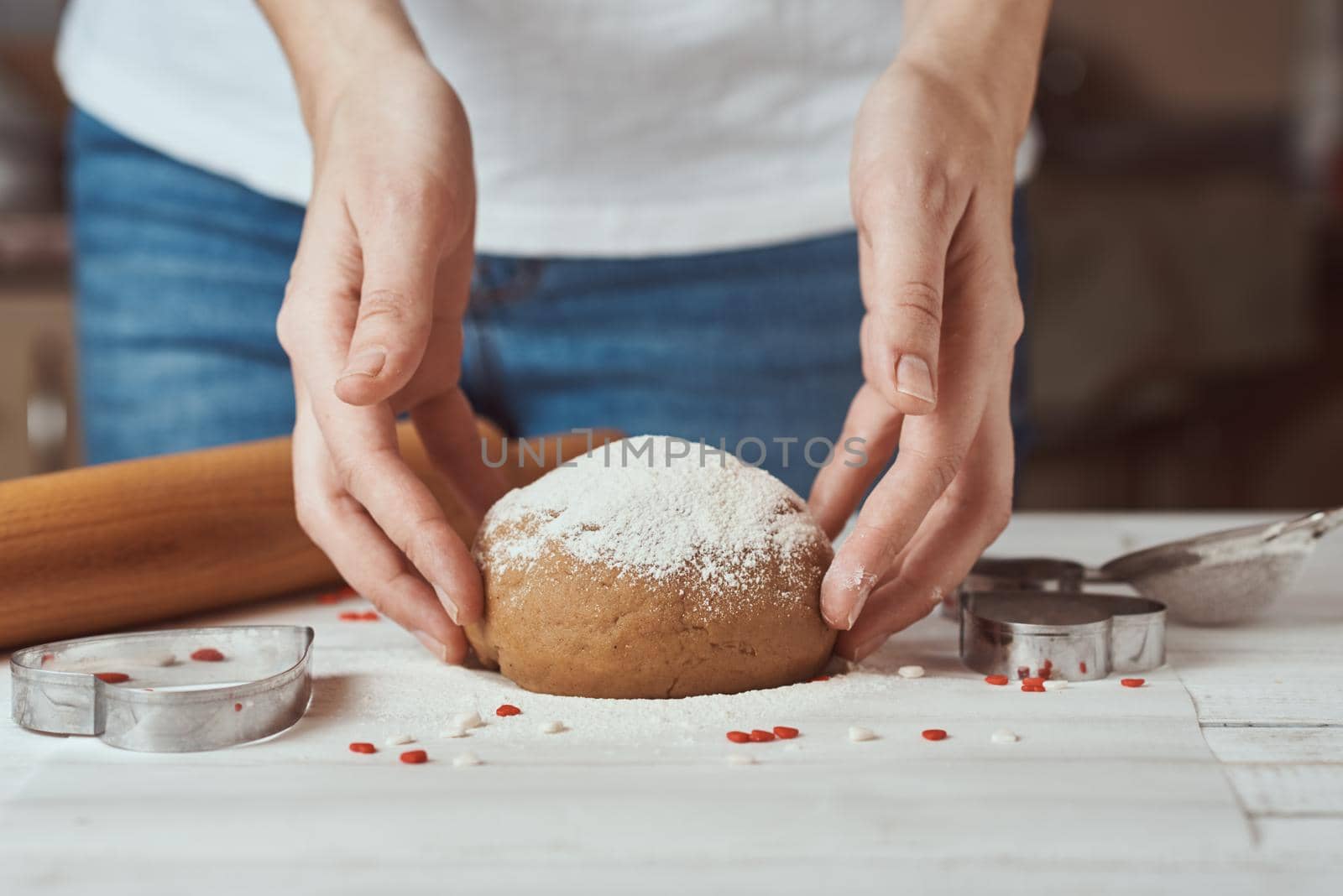 Woman kneads dough with hands in the kitchen by Lazy_Bear