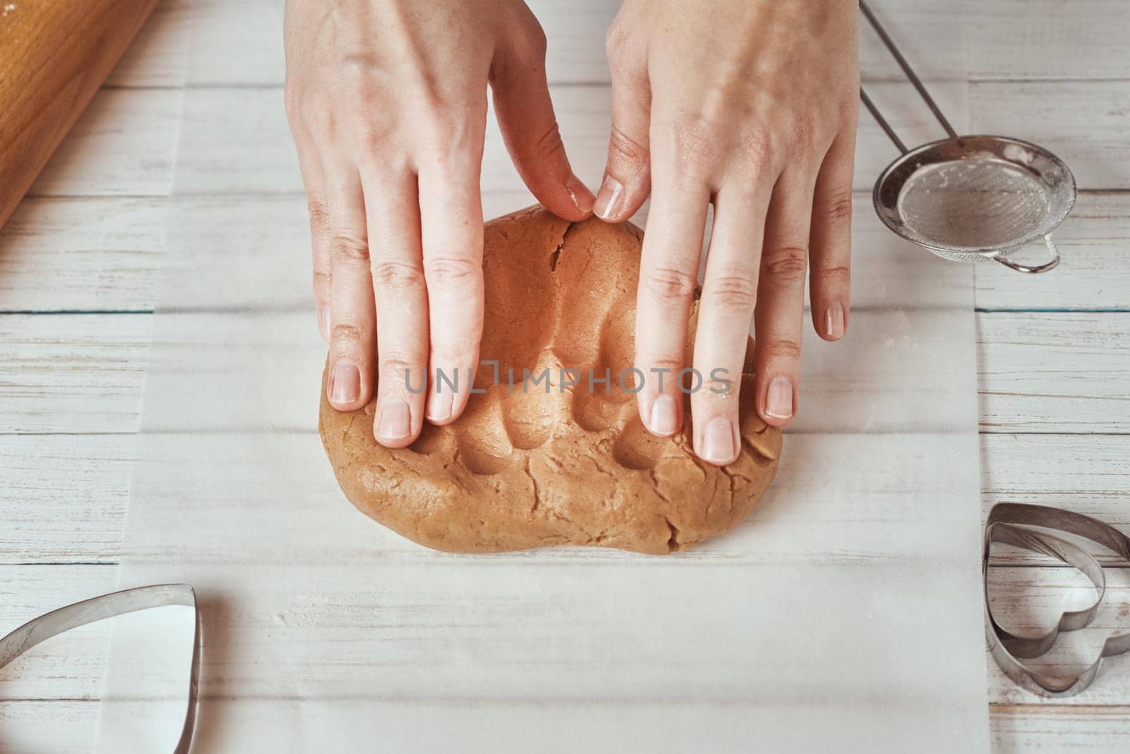 Woman kneads dough with hands in the kitchen by Lazy_Bear