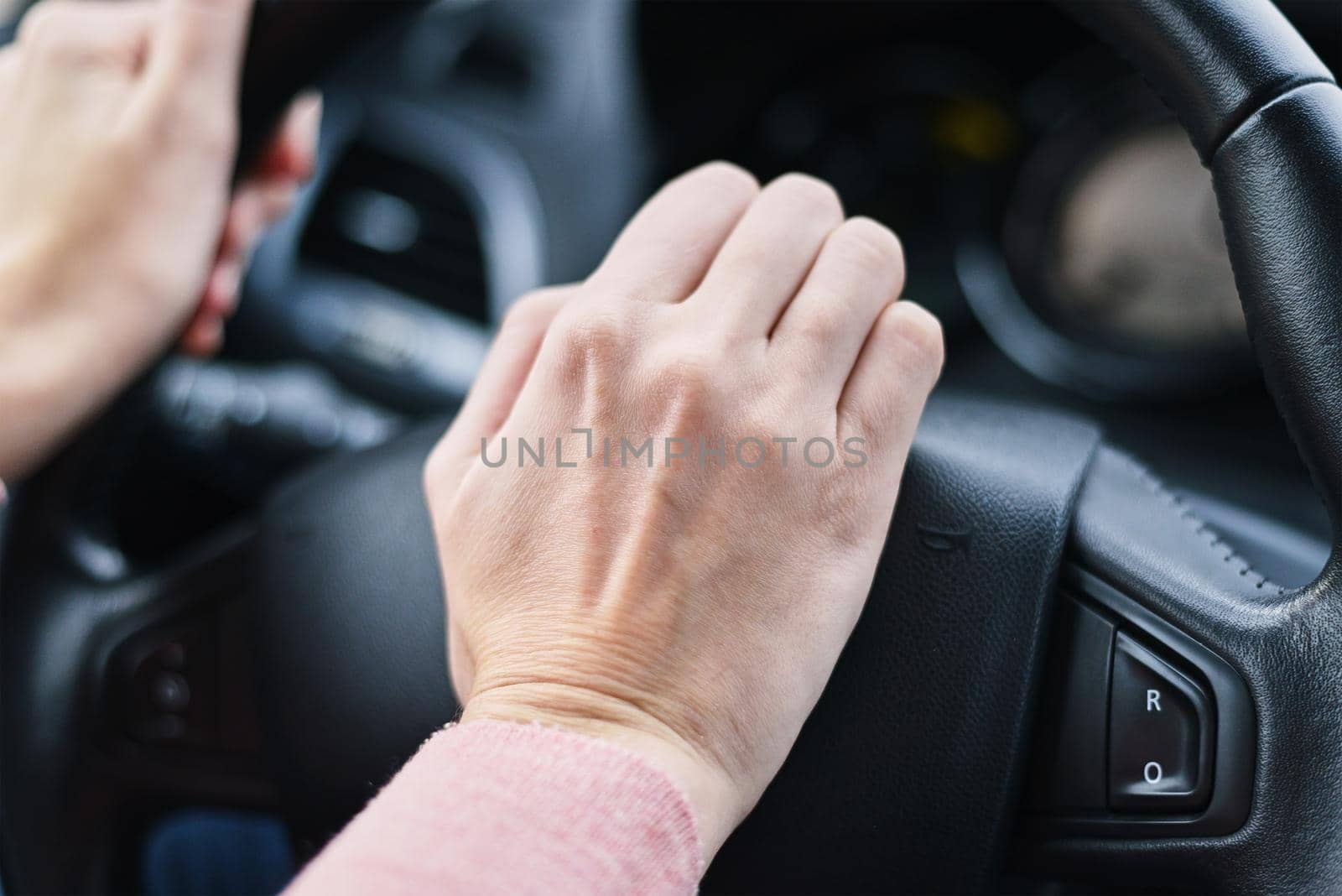 Driver hand pressed horn button on the car wheel by Lazy_Bear