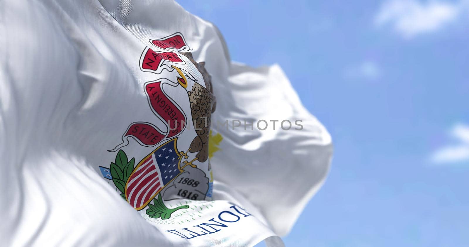 The US state flag of Illinois waving in the wind. Illinois is a state in the Midwestern region of the United States. Democracy and independence.