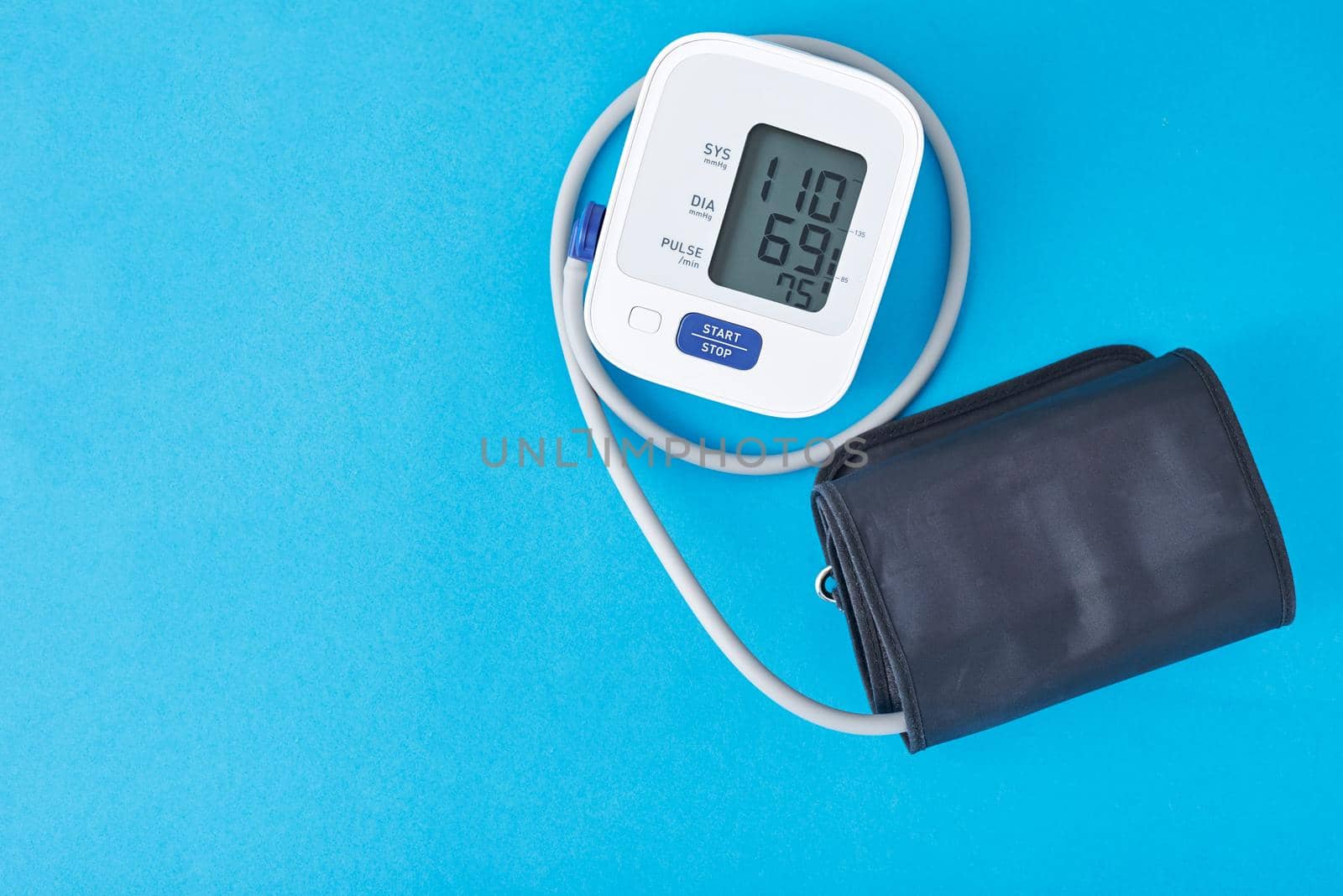 Digital blood pressure monitor on a blue background, closeup. Helathcare and medical concept by Lazy_Bear