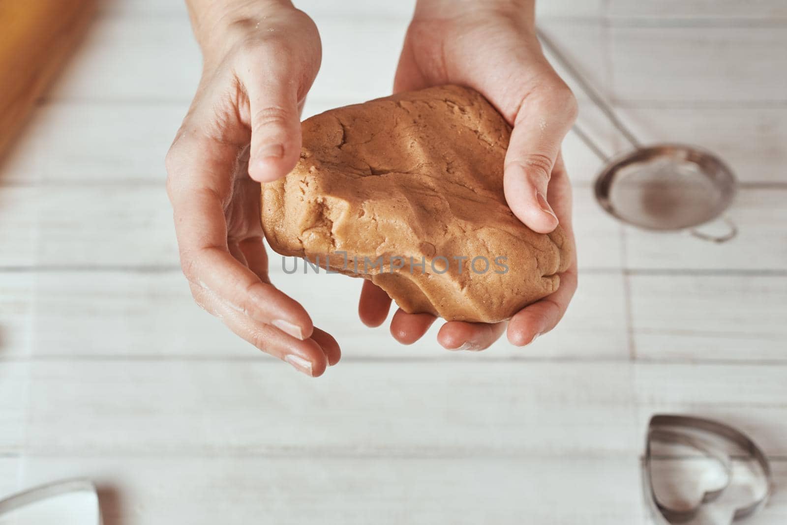 Woman kneads dough with hands in the kitchen by Lazy_Bear