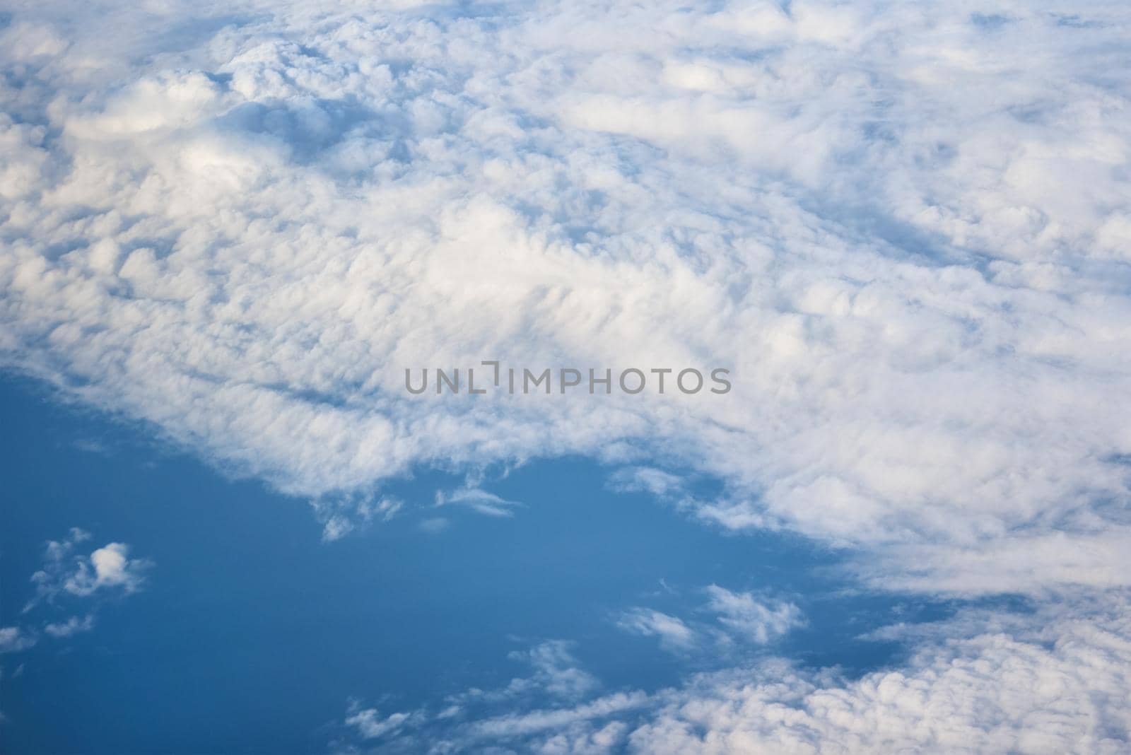 Aerial view of fluffy clouds. Top view of beautiful cloudscape and blue sky