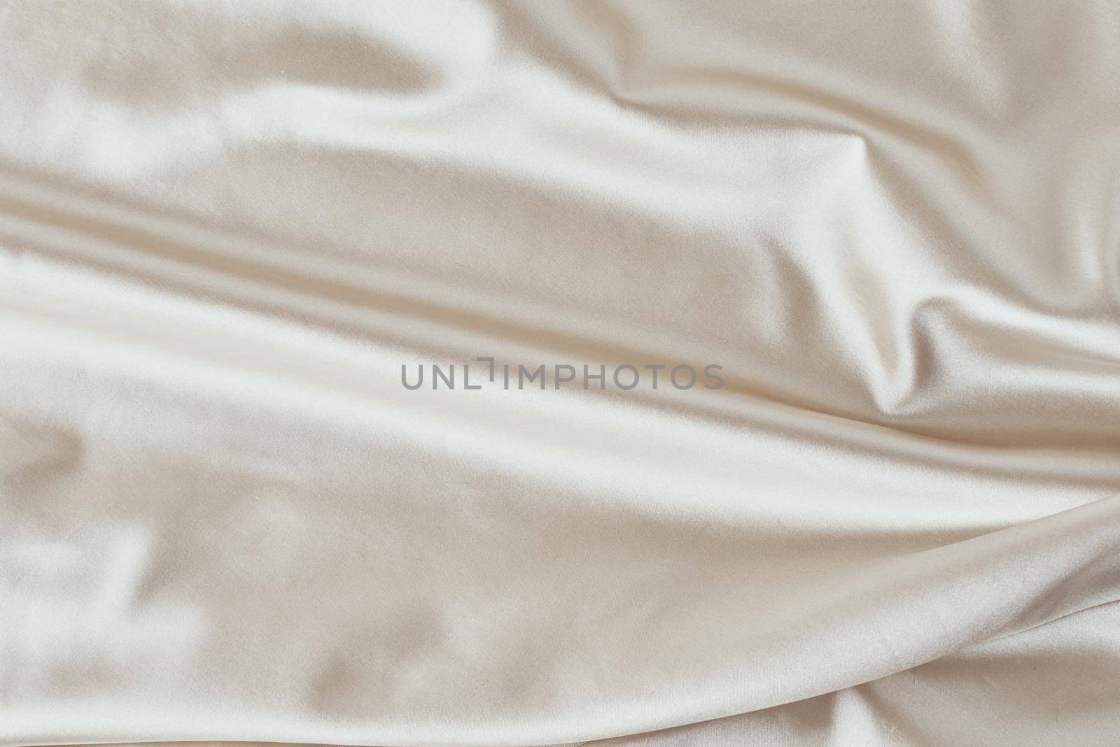 Golden light silk background with a folds. Abstract texture of rippled satin surface by Lazy_Bear