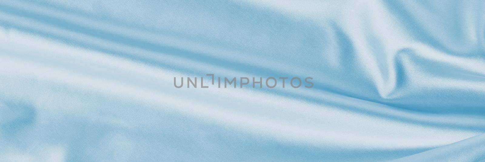 Light blue silk background with folds. Abstract texture of rippled satin surface, long banner