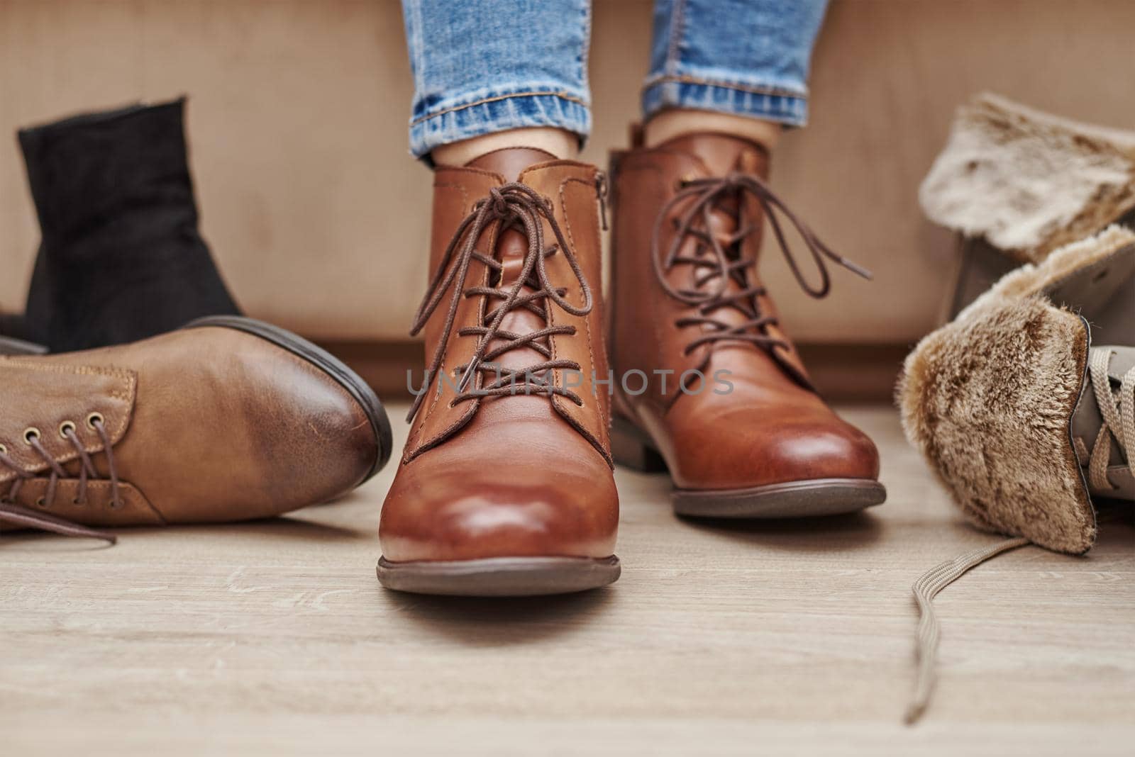 Woman chooses comfortable brown leather shoes among bunch of the different pairs by Lazy_Bear