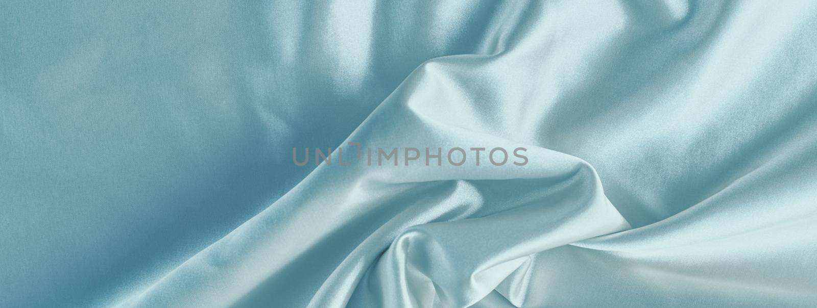 Light blue silk background with folds. Abstract texture of rippled satin surface, long banner