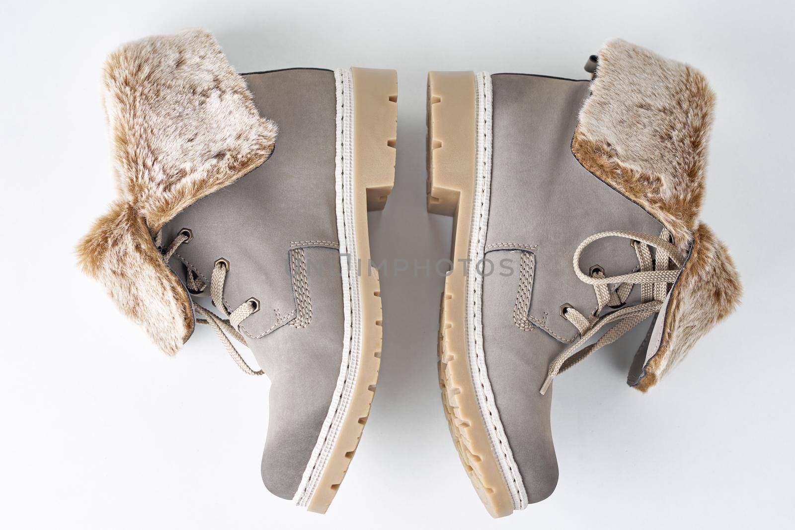 Pair of winter womens boots on the white background isolated, top view by Lazy_Bear