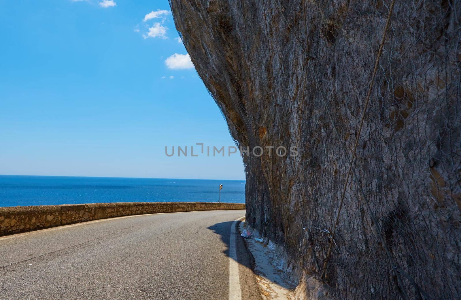 Asphalt road. Colorful landscape with beautiful mountain road with a perfect asphalt. High rocks, blue sky at sunrise in summer. Vintage toning. Travel background. Highway at mountains by sarymsakov