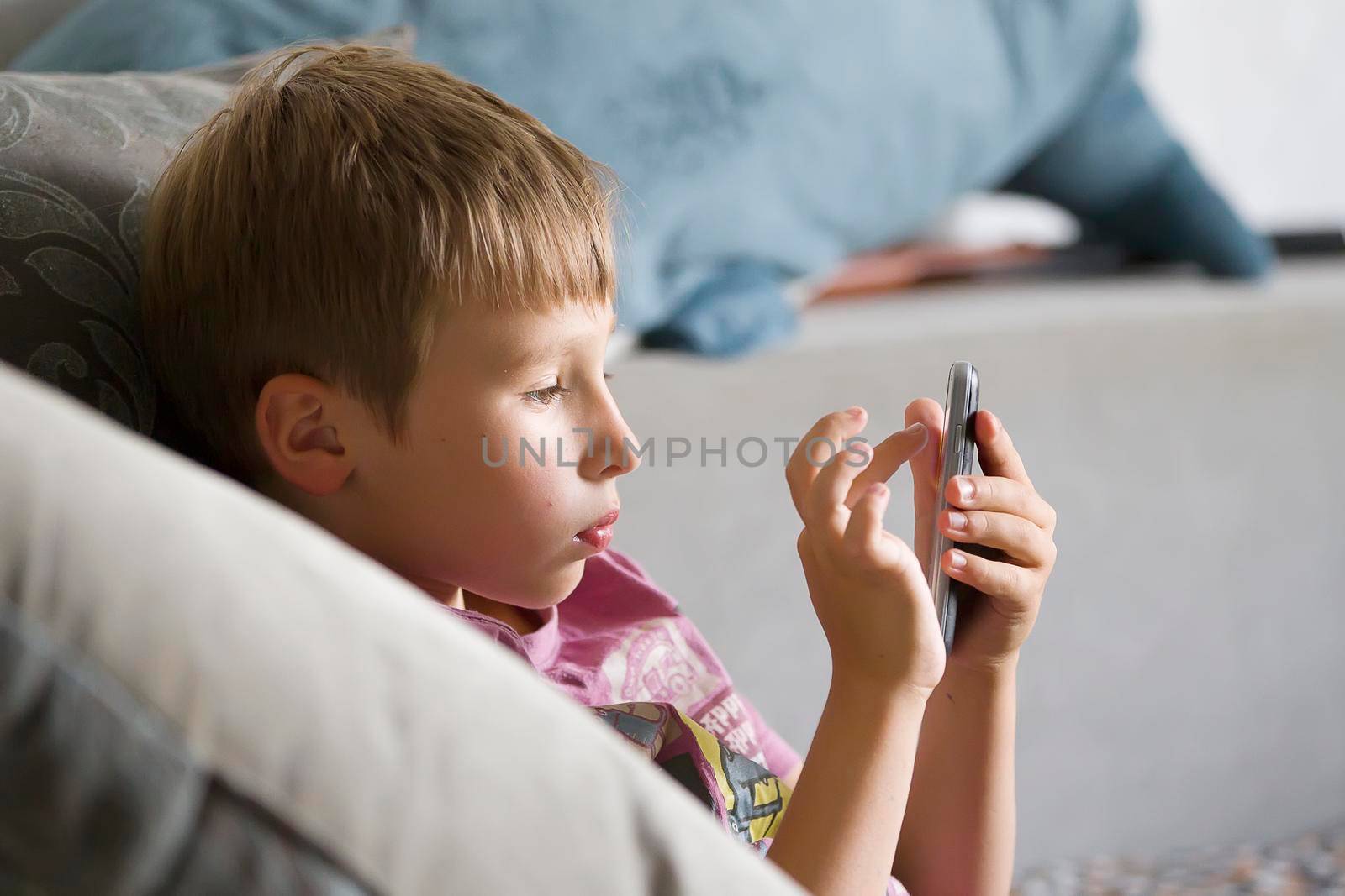 Child with a mobile phone. Boy of school age with a gadget