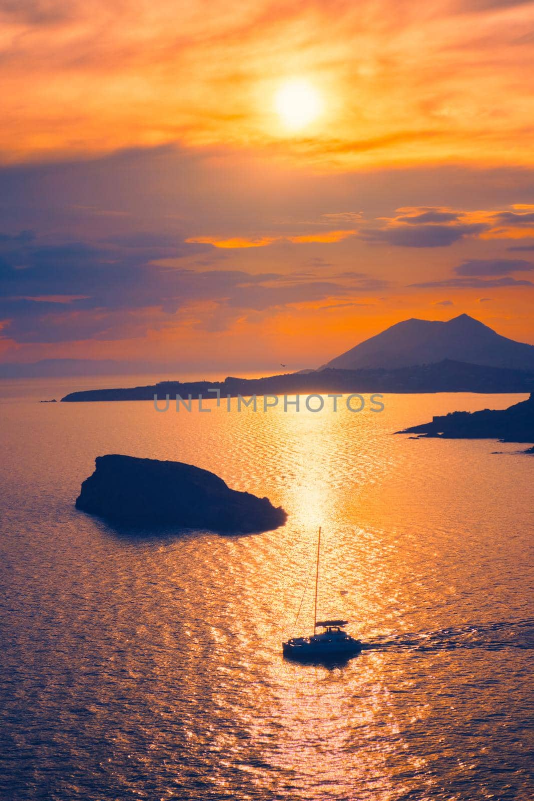 Aegean Sea with Greek islands view on sunset with yacht in sea. Cape Sounion, Greece