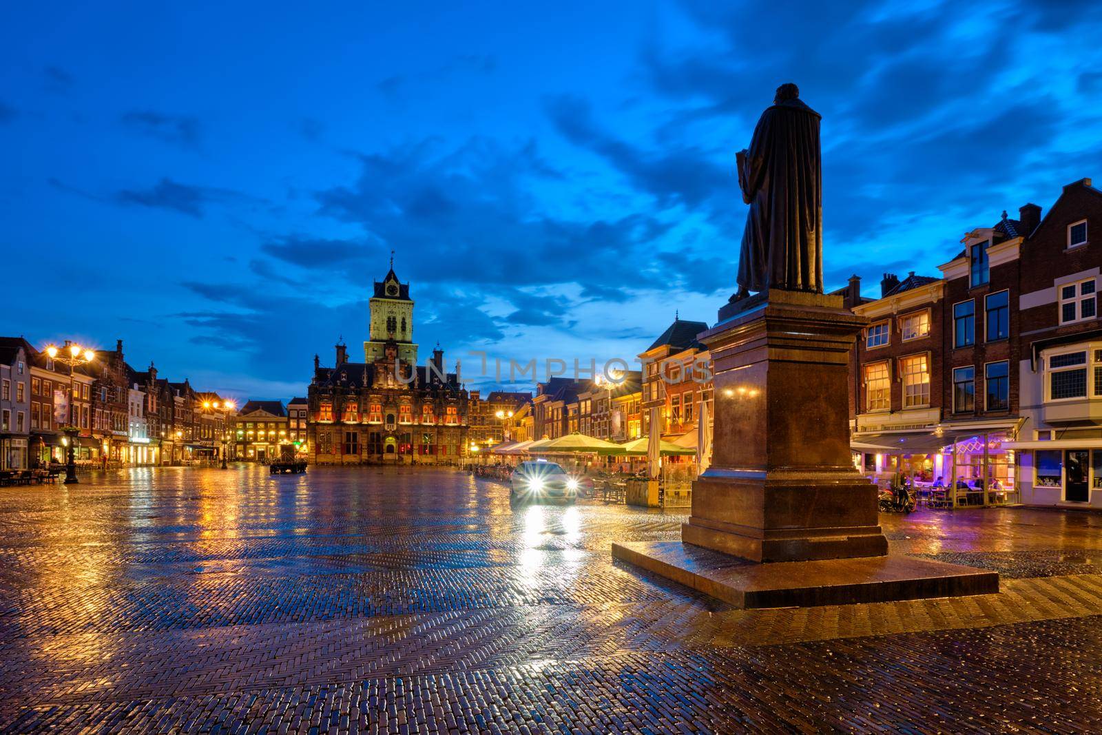 Delft City Hall and Delft Market Square Markt with Hugo de Groot Monument in the evening. Delfth, Netherlands