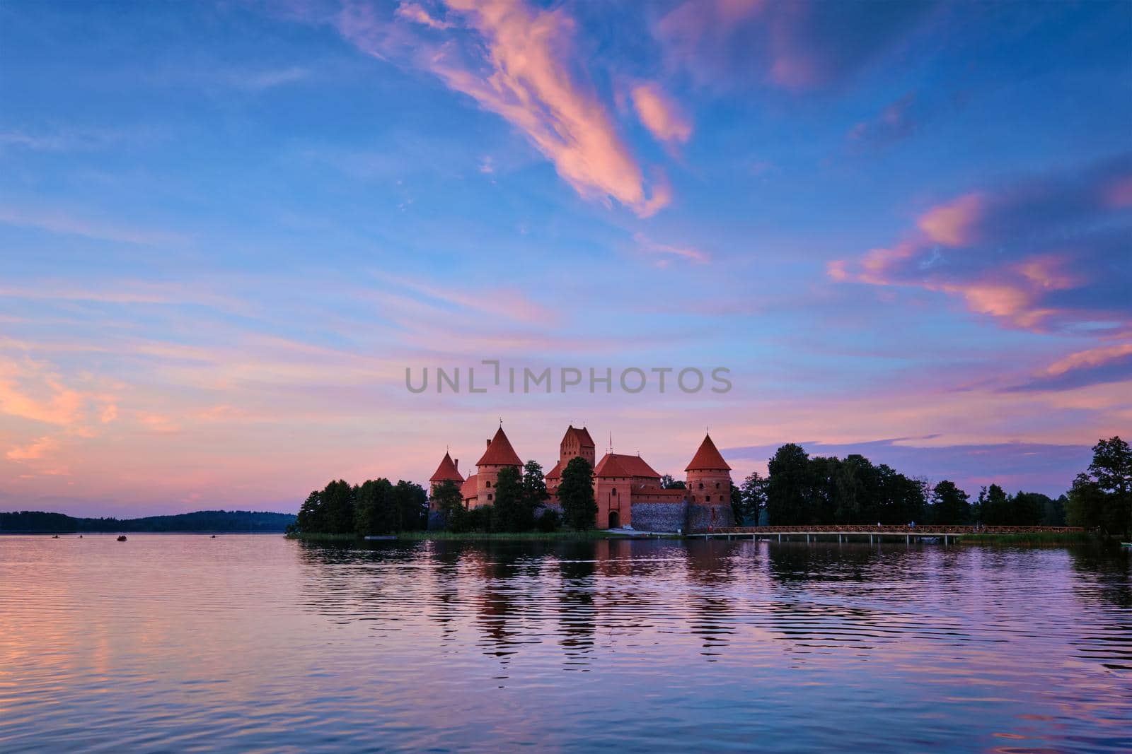 Trakai Island Castle in lake Galve, Lithuania on sunset with dramatic sky reflecting in water. Trakai Castle is one of major tourist attractions of Lituania