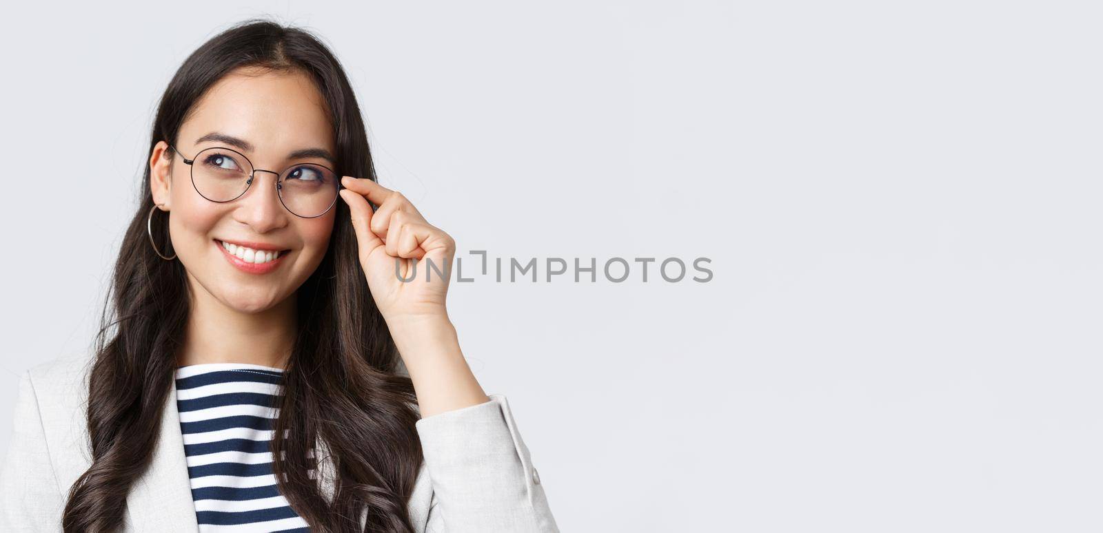 Business, finance and employment, female successful entrepreneurs concept. Close-up of dreamy and thoughtful smart asian woman, office worker in glasses, smiling and looking left.