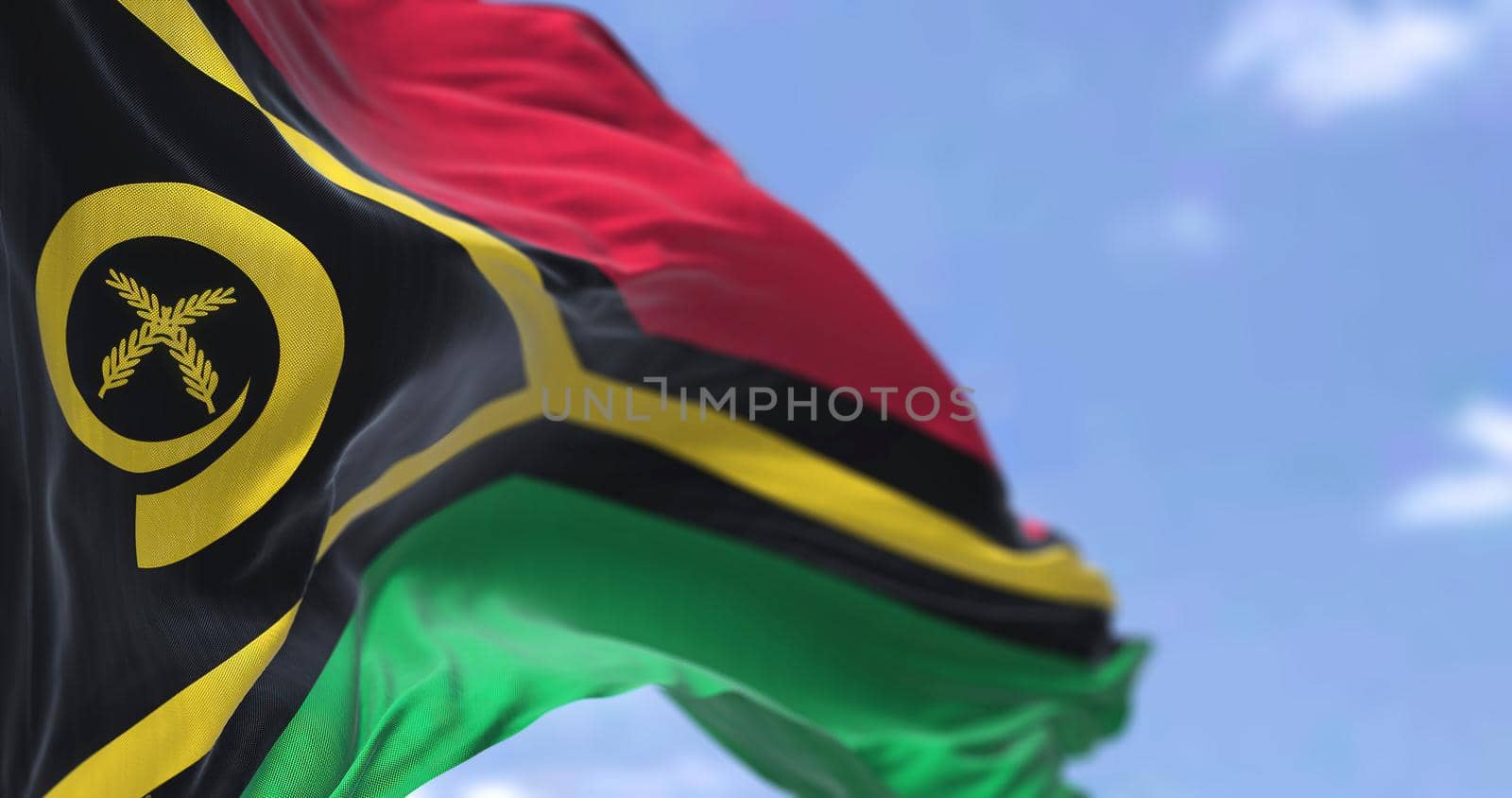 Detail of the national flag of Vanuatu waving in the wind on a clear day by rarrarorro