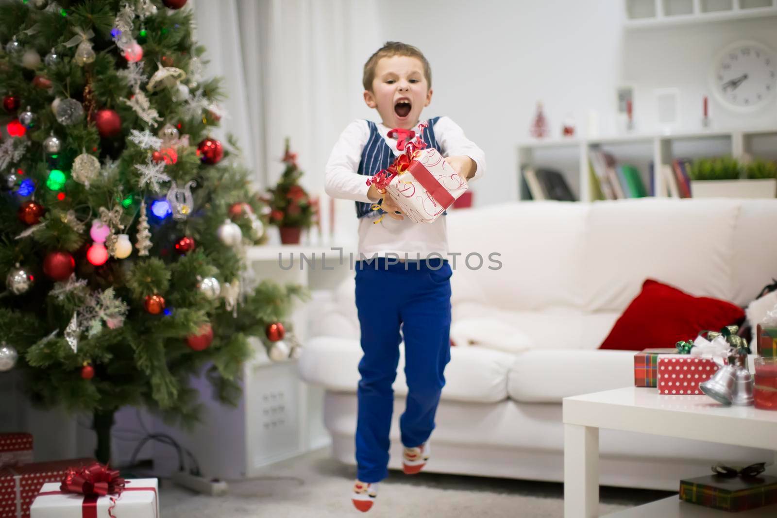 A boy with a New Year's gift. Happiness is Christmas.