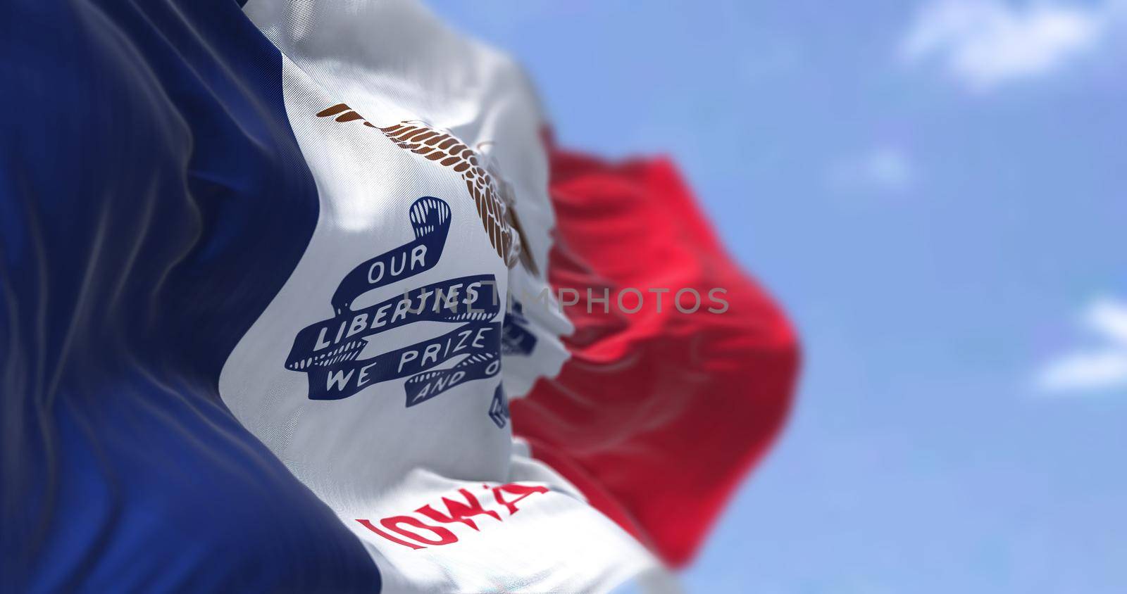 The US state flag of Iowa waving in the wind. Iowa is a state located in the midwestern region of the United States. Democracy and independence.