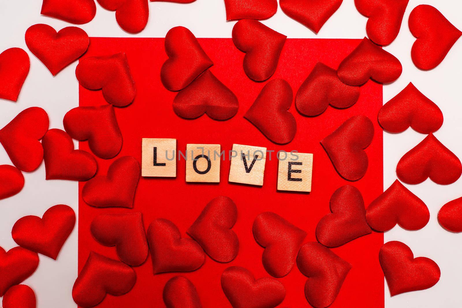 Top view of the inscription with the word love on a red background. Love concept, valentine's day