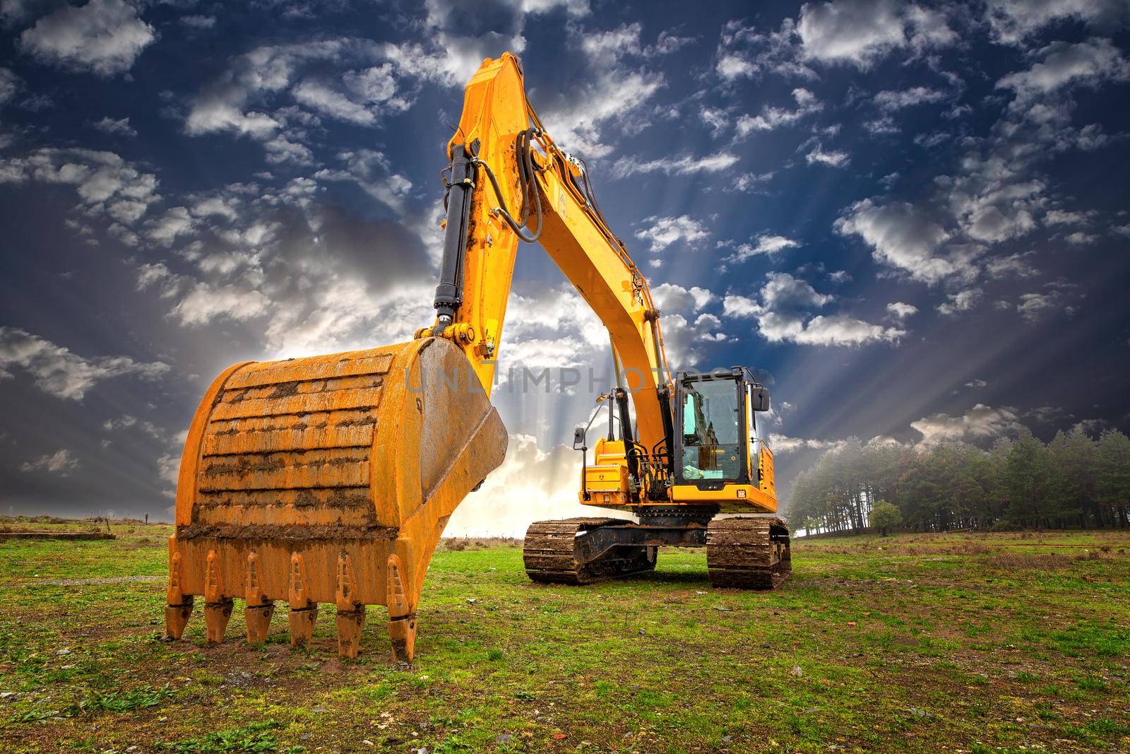 A stopping yellow excavator at an incredibly beautiful sky by EdVal