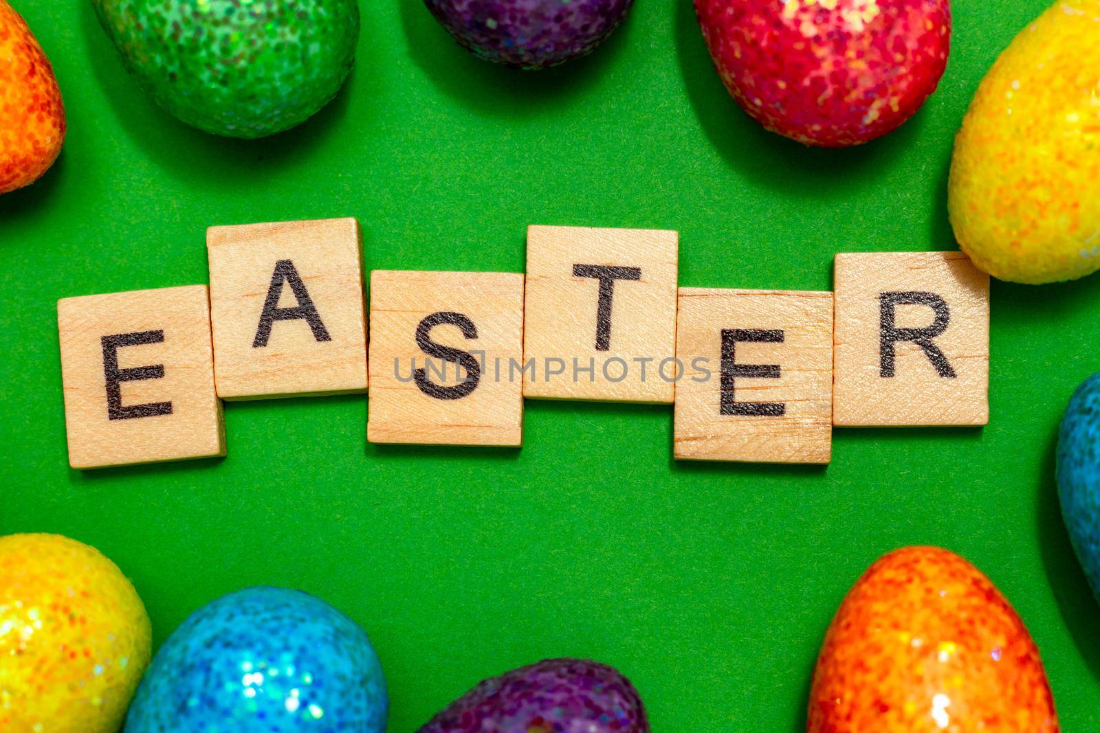 Easter card with eggs on a green background and the inscription Easter. Easter spring break concept.