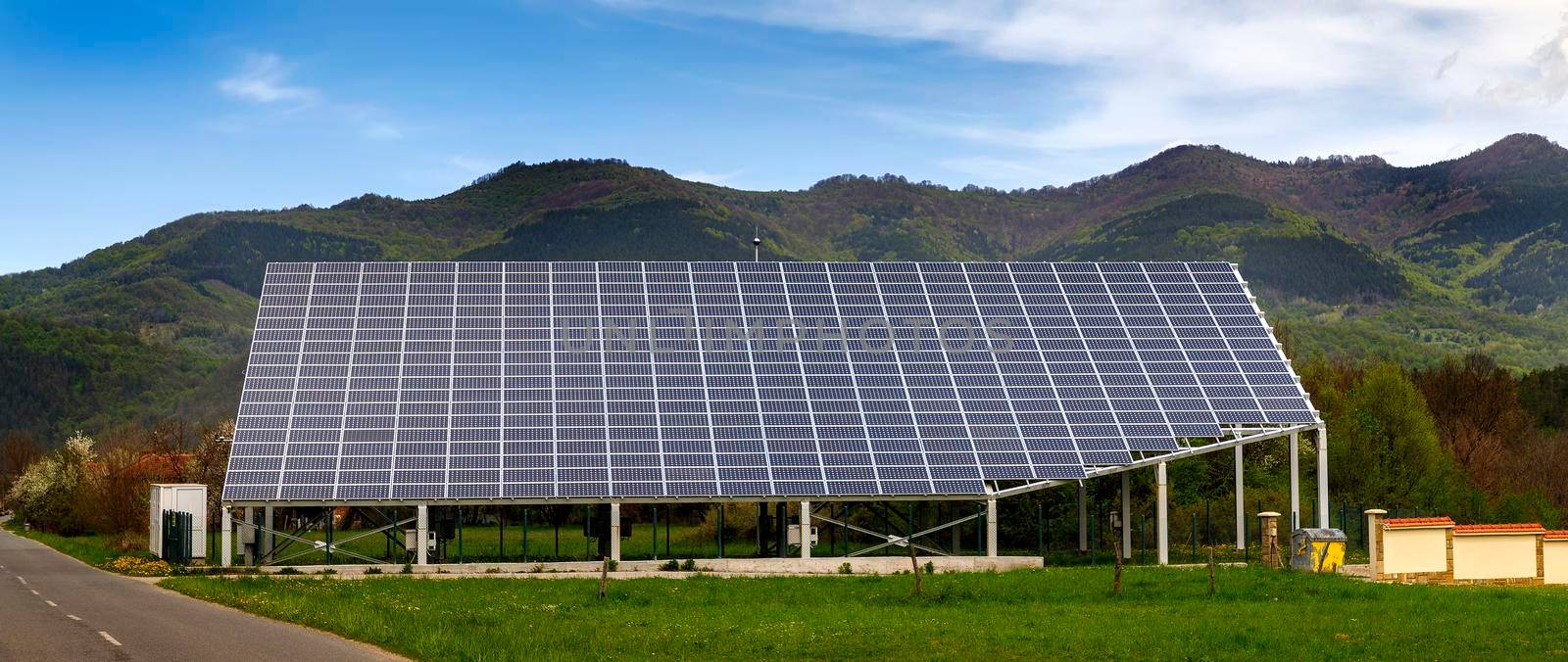 solar panels on the roof of a house. horizontal orientation, a mountain in the background by EdVal