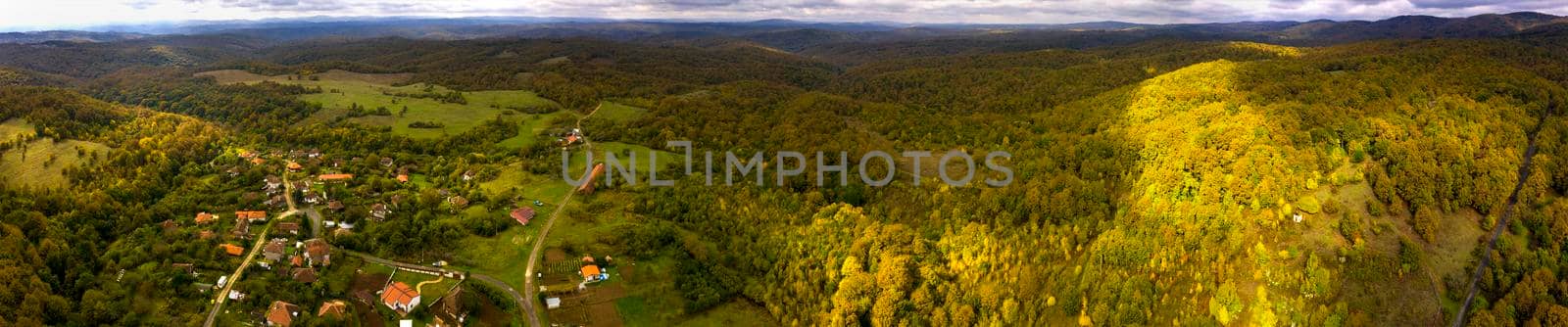 Beautiful aerial panorama of mountain village at hills  by EdVal