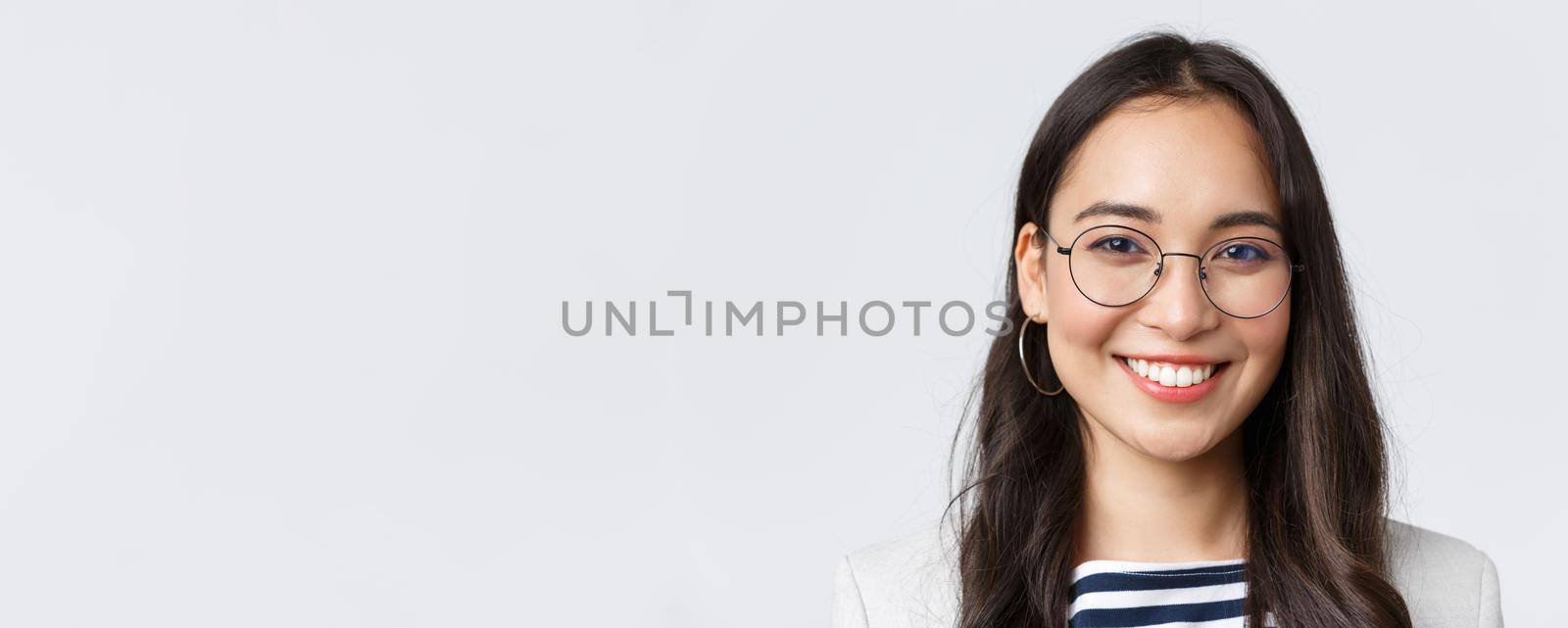 Business, finance and employment, female successful entrepreneurs concept. Good-looking asian businesswoman in glasses and suit smiling friendly and confident, working in office by Benzoix